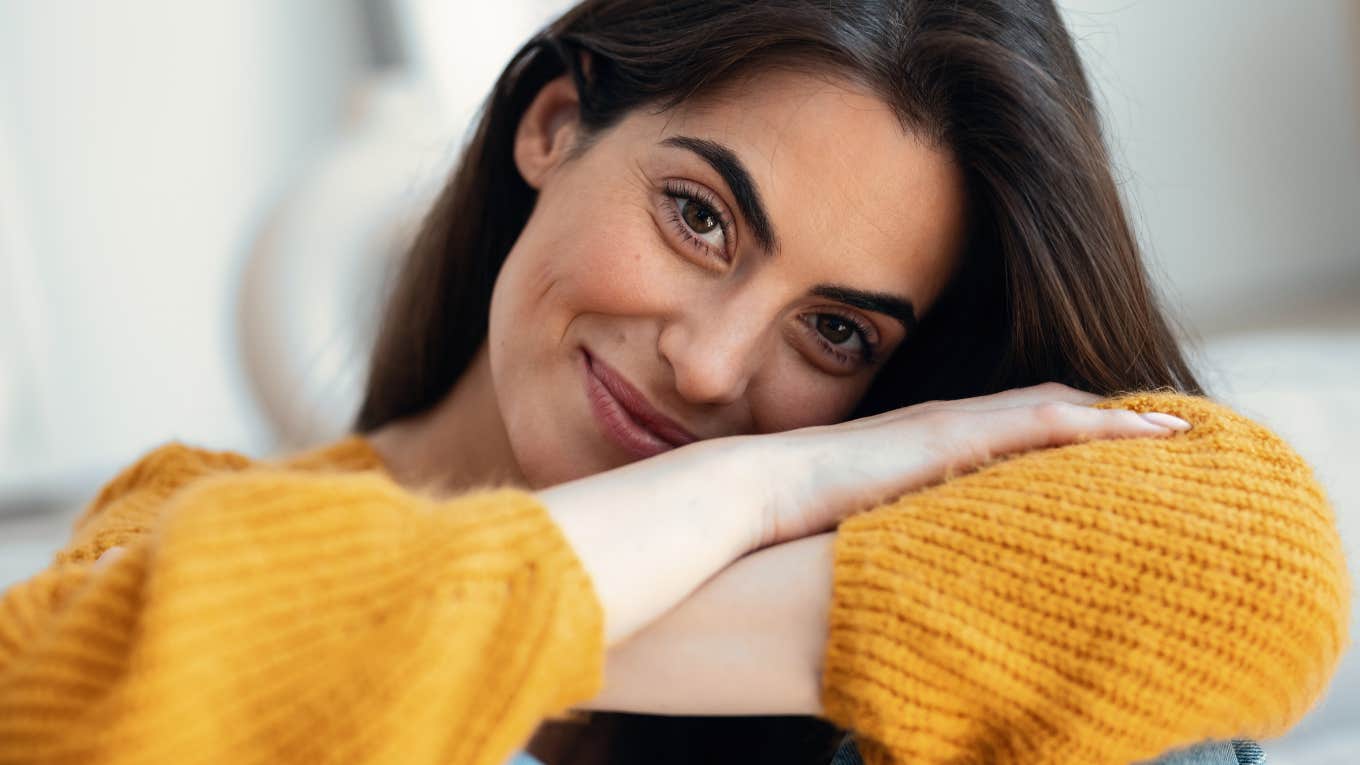 Things Introverts Do On A Regular Basis That Confuse An Average Person introverted woman smiling comfortably at home