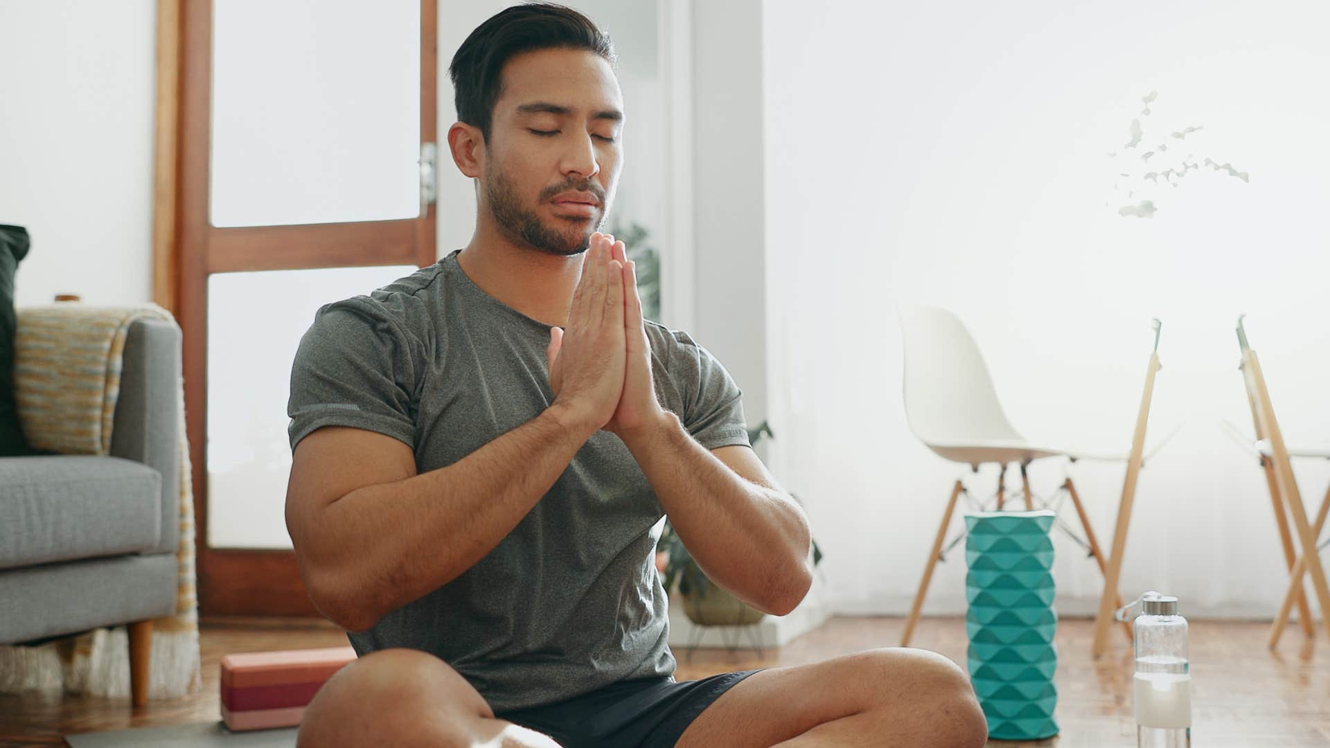introverted man practicing meditation and mindfulness at home