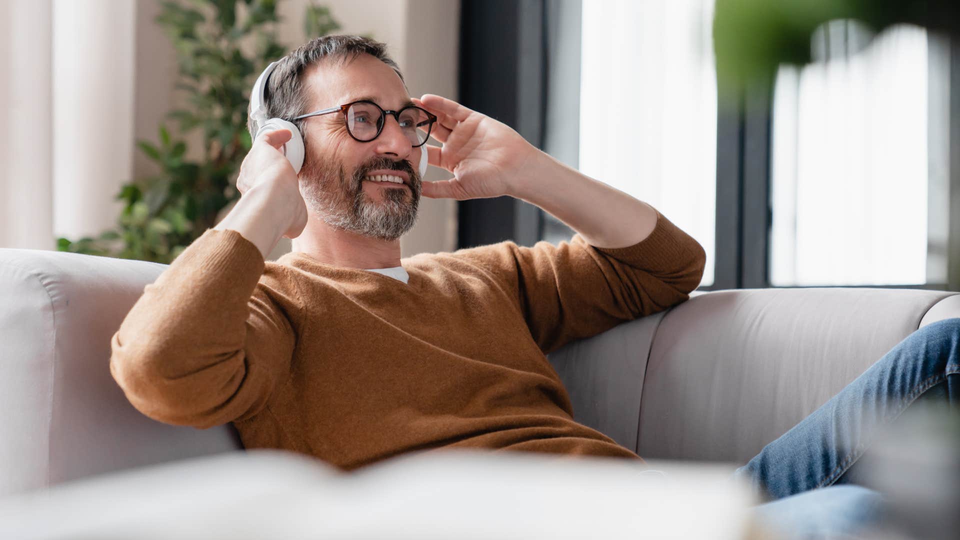 relaxed man staying home on the weekends listening to music