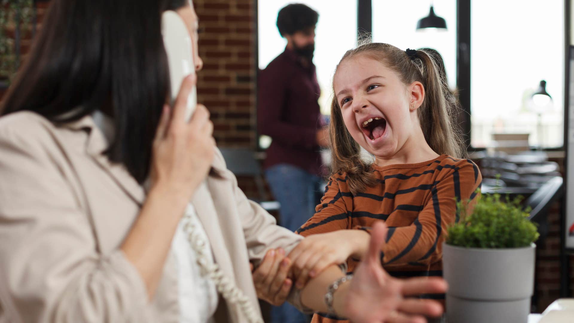 Little girl interrupting others on the phone.