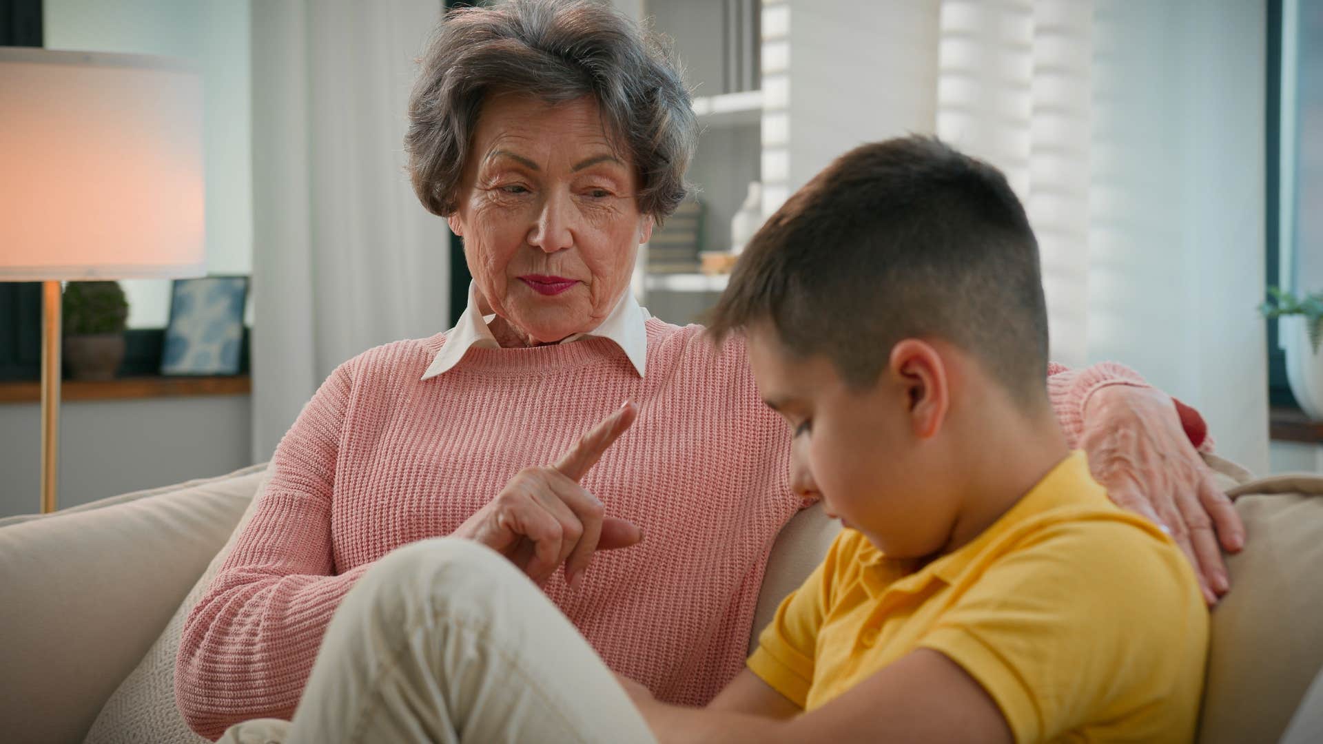Little boy questioning authority next to his grandmother.