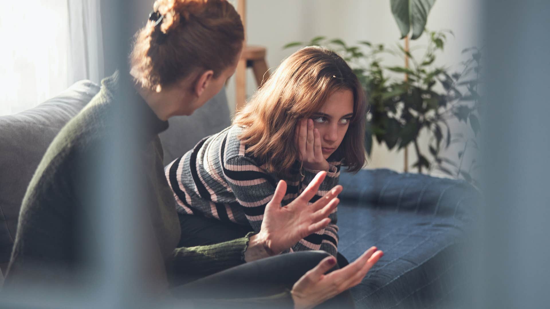 Teenage girl struggling to accept "no" next to a therapist.