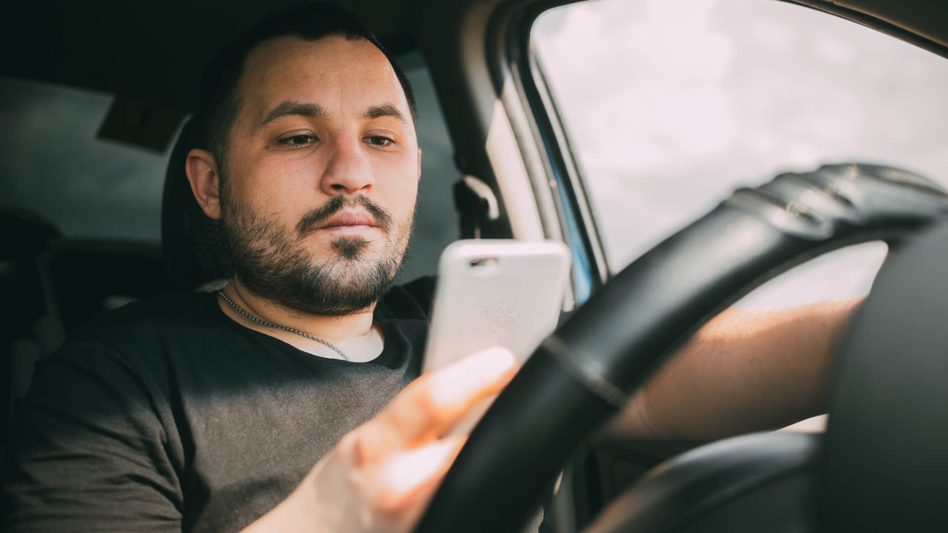 Man breaking social norms and rules in his car.
