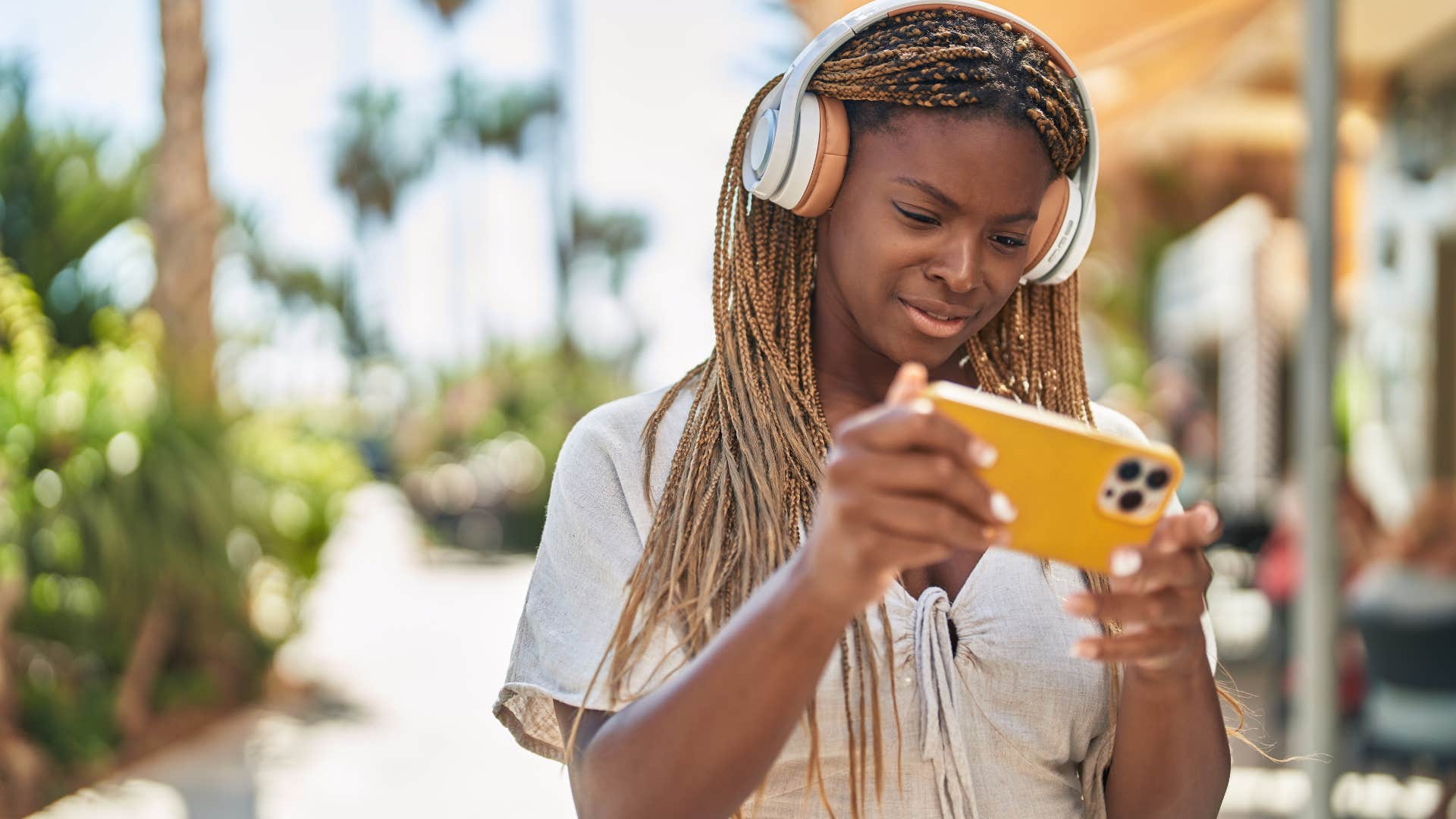 Woman casually gaming on her phone.