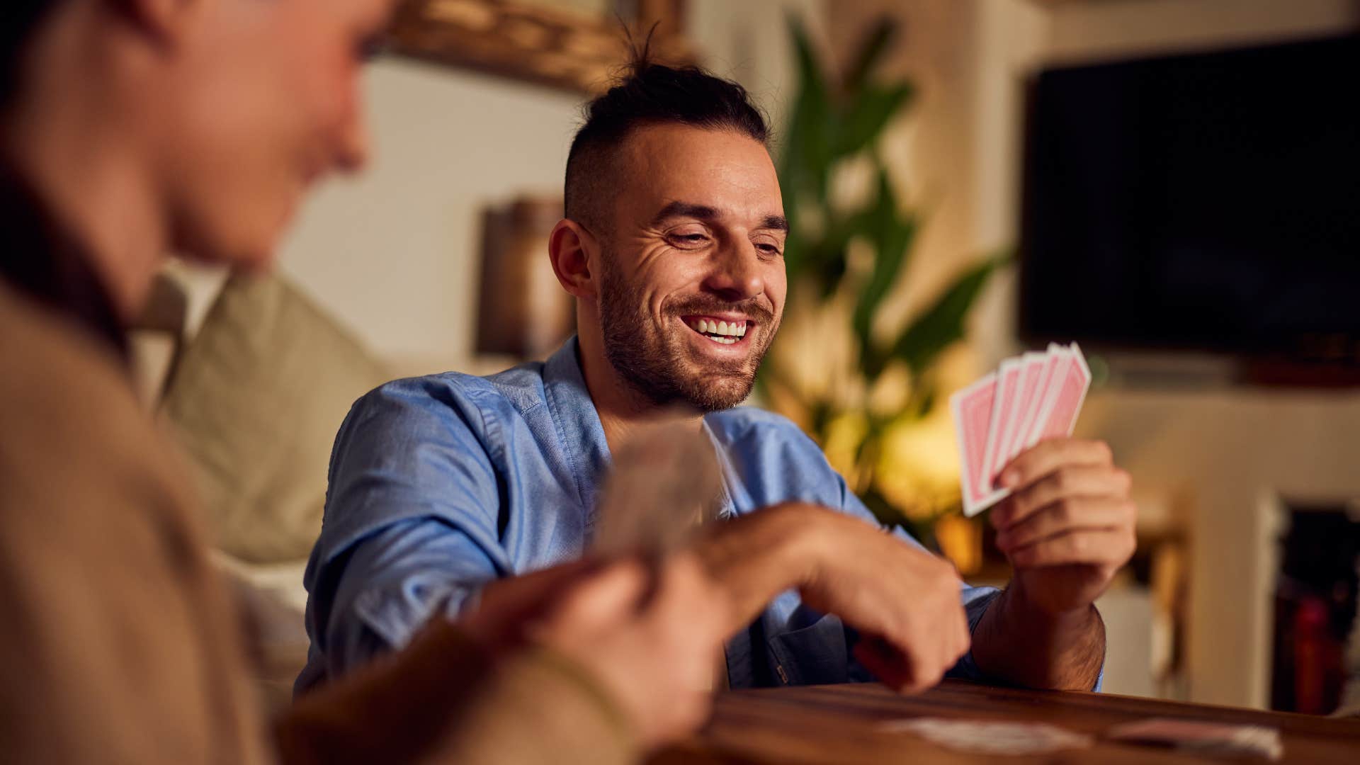 Man playing luck-based games with friends at home.