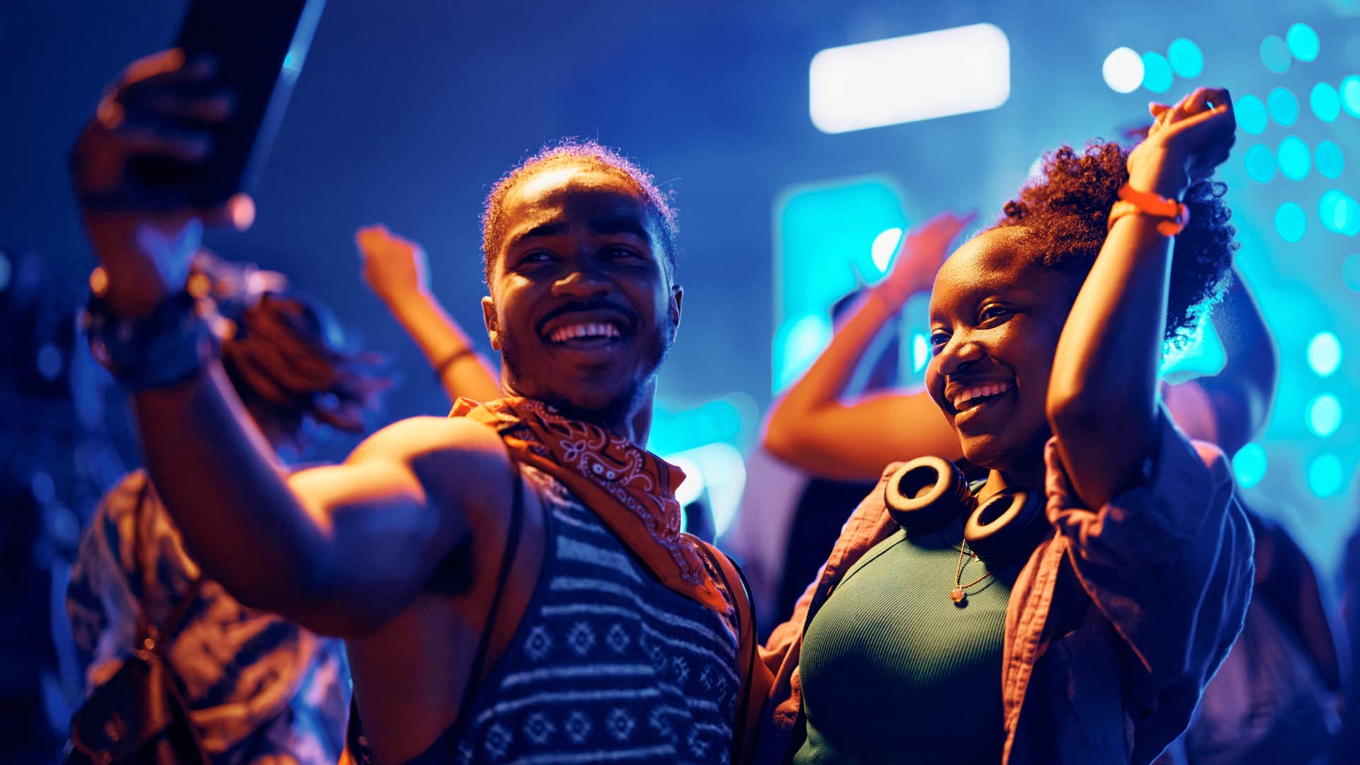 couple dancing to loud music with visuals at a concert