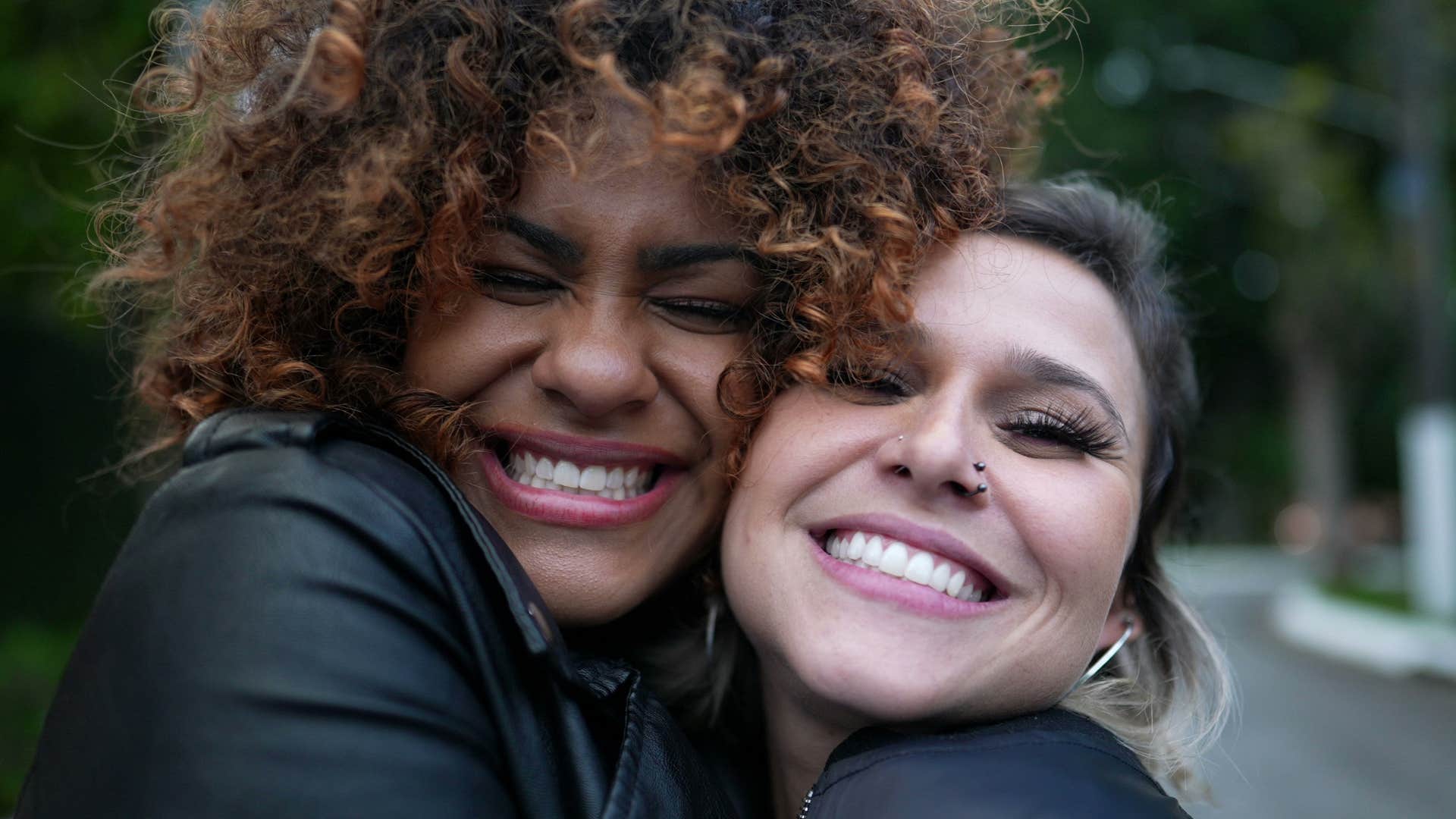 two women going out and smiling