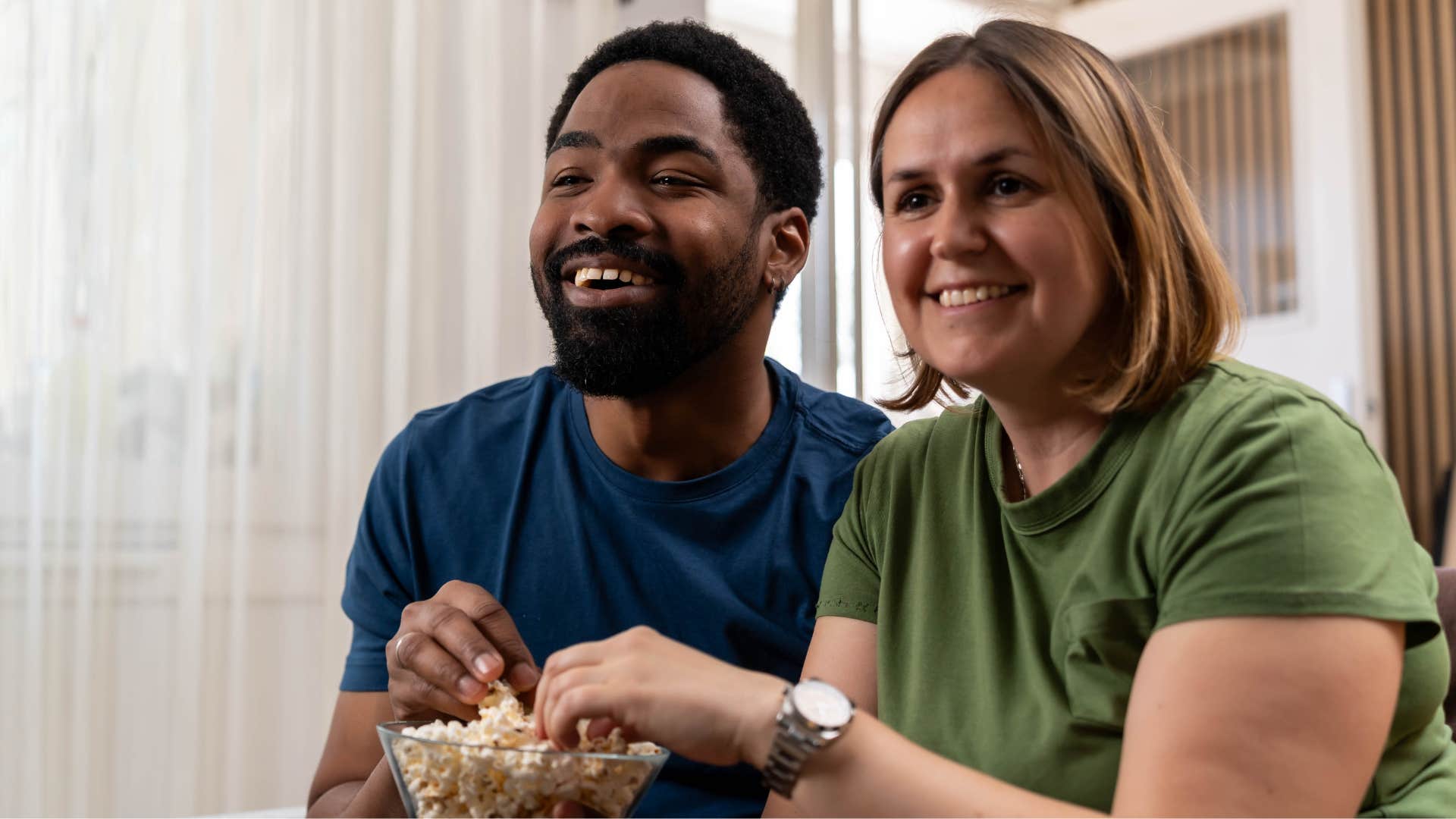 couple smiling and rewatching movies