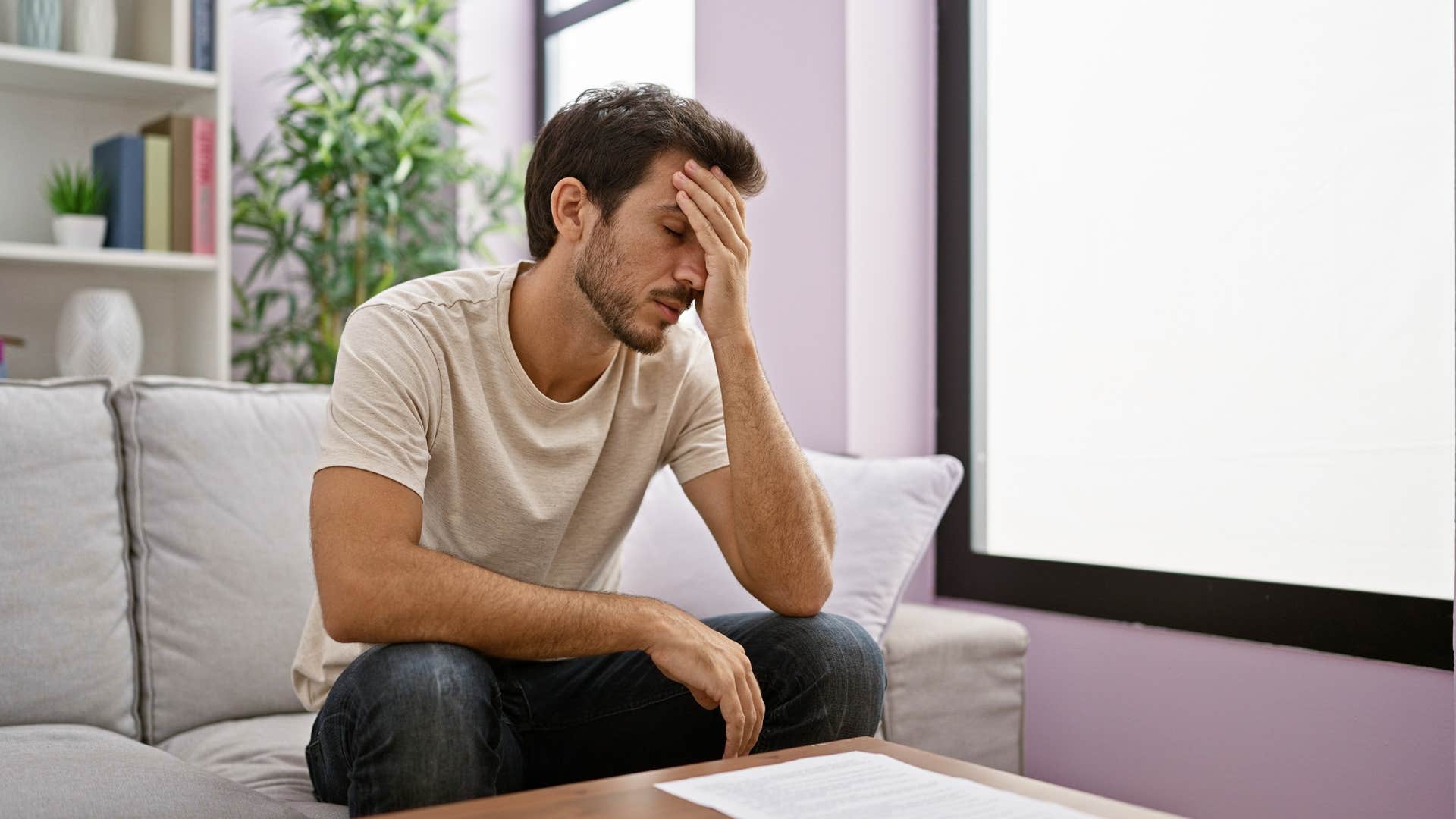 man struggling with financial stress thinking hes fine