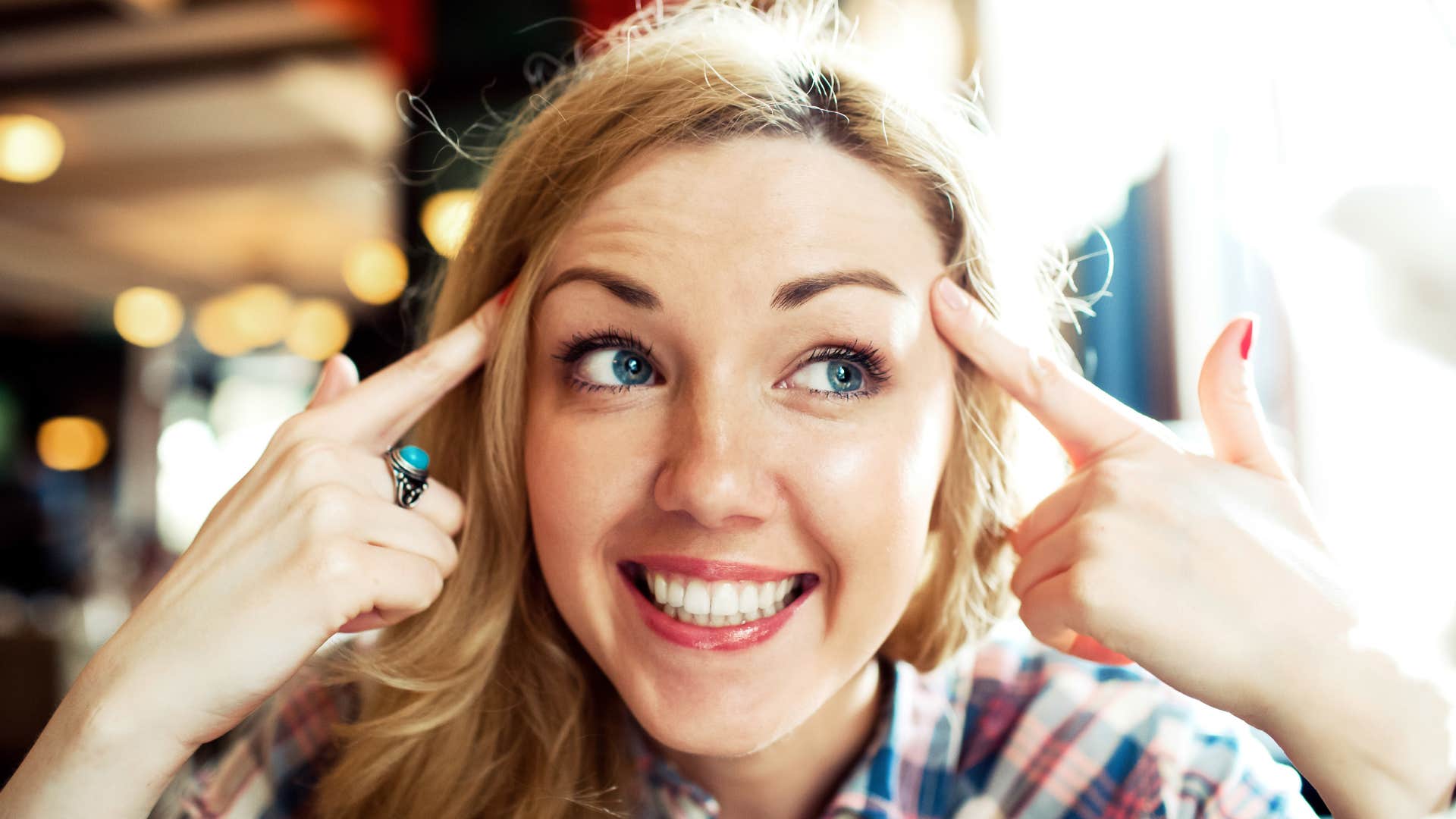 overthinking woman pointing to her head