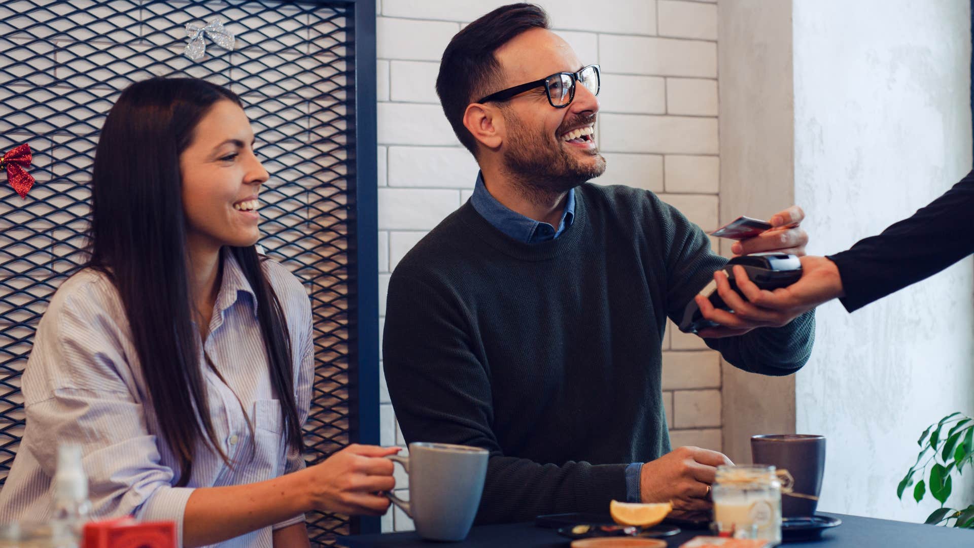 Man wearing subtly expensive clothing at a restaurant.