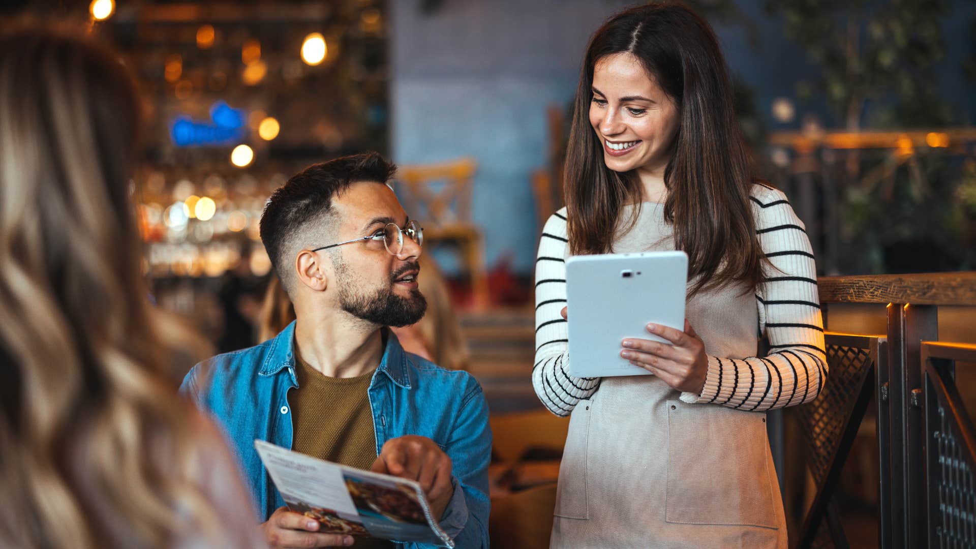 Man ordering without checking prices at a restaurant.