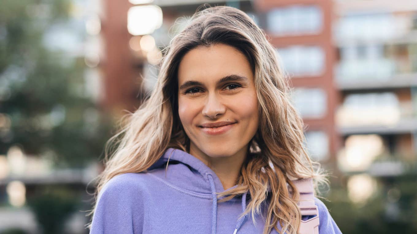 woman who grew up rich smiling happily