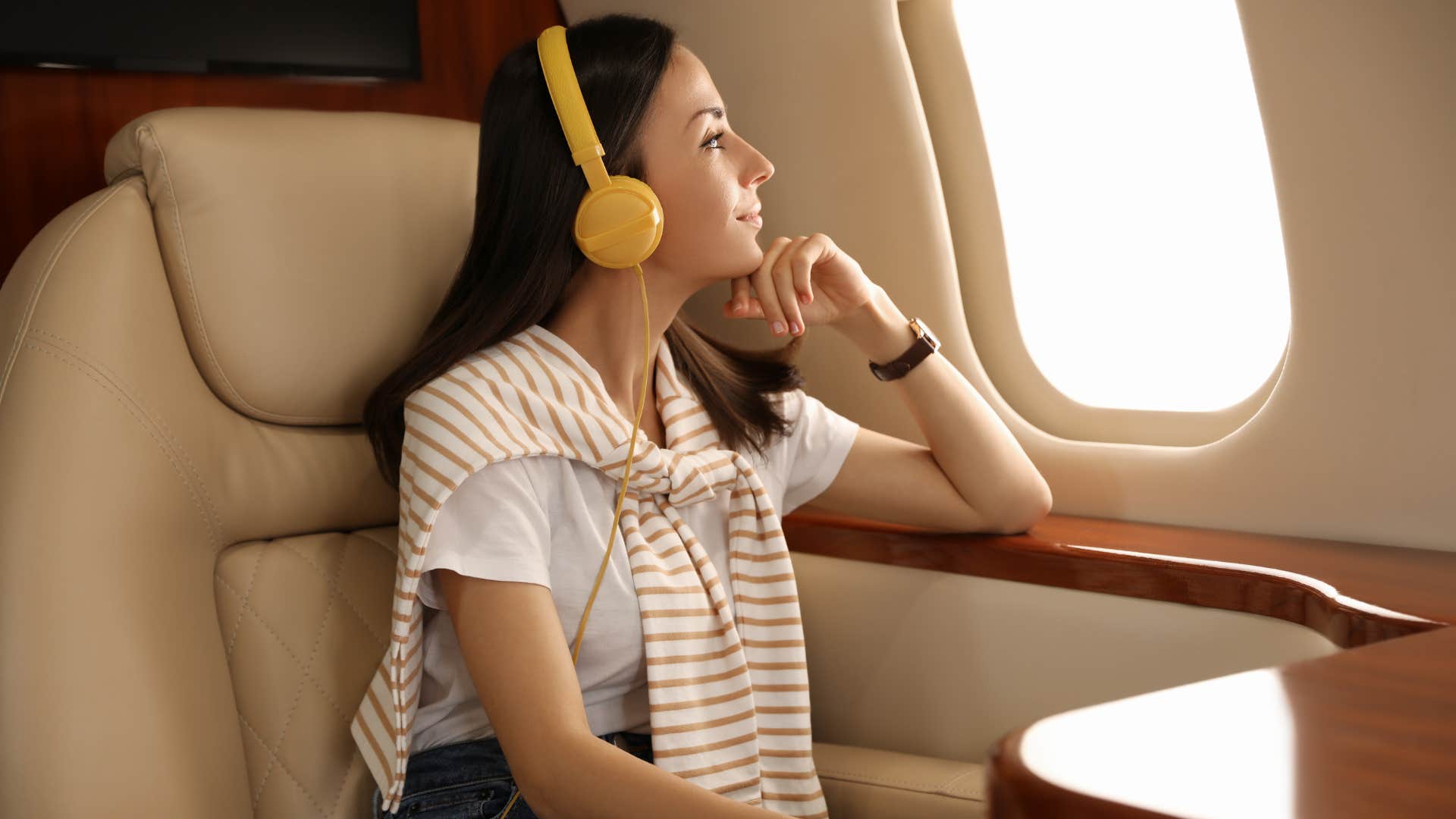 wealthy woman sitting in first class on plane