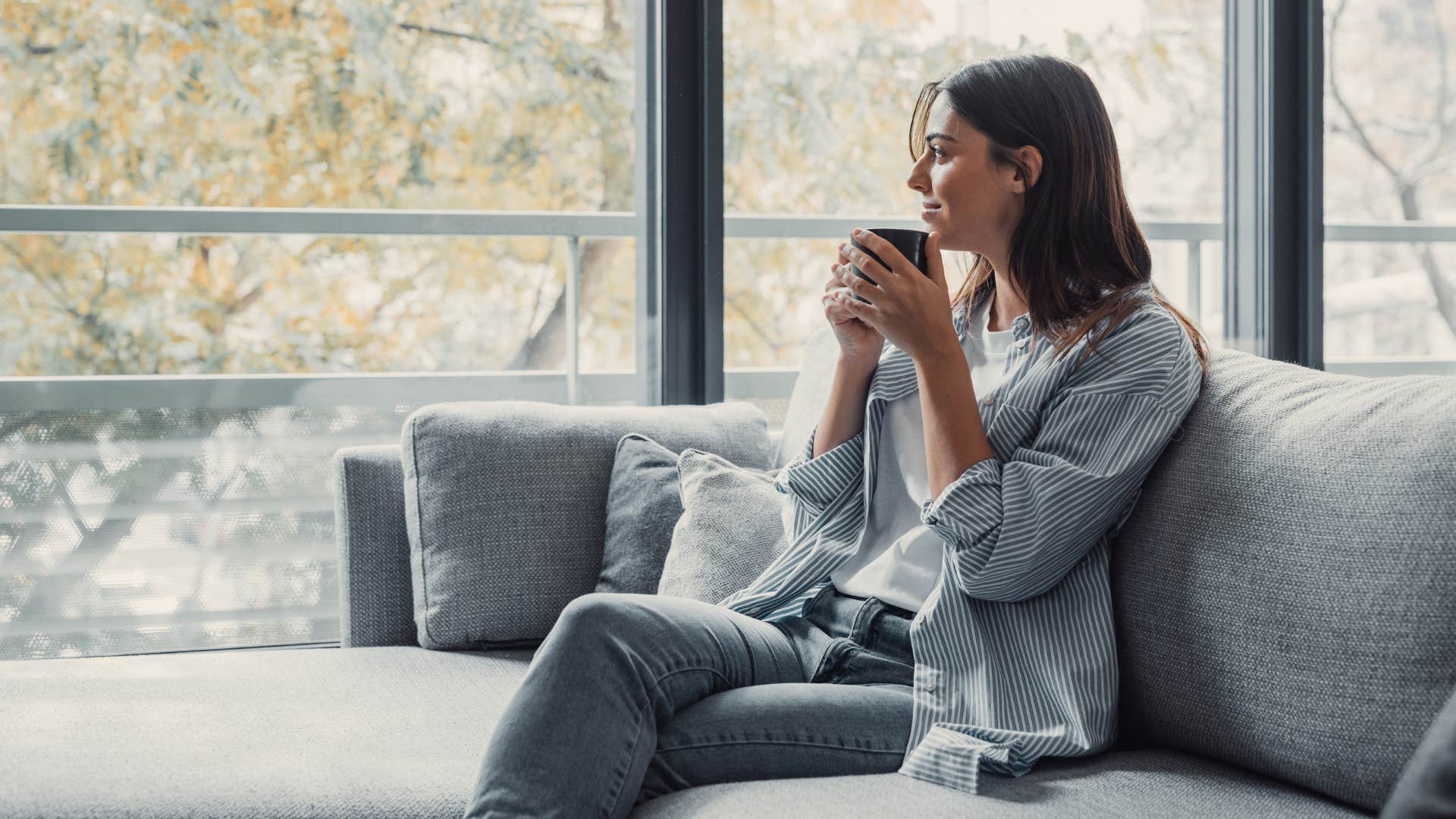 wealthy woman drinking tea sitting in flashy home