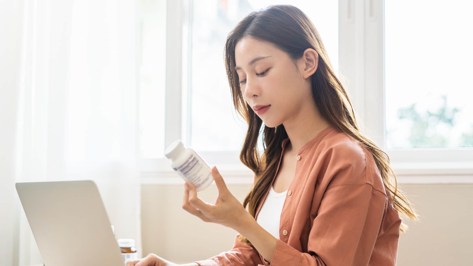 woman about to take supplements
