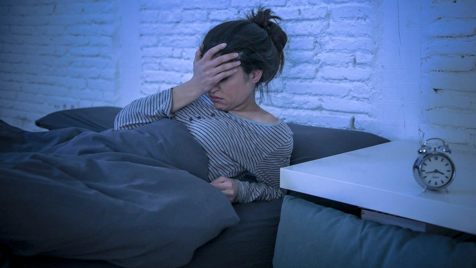 woman with high anxiety being unable to fall asleep