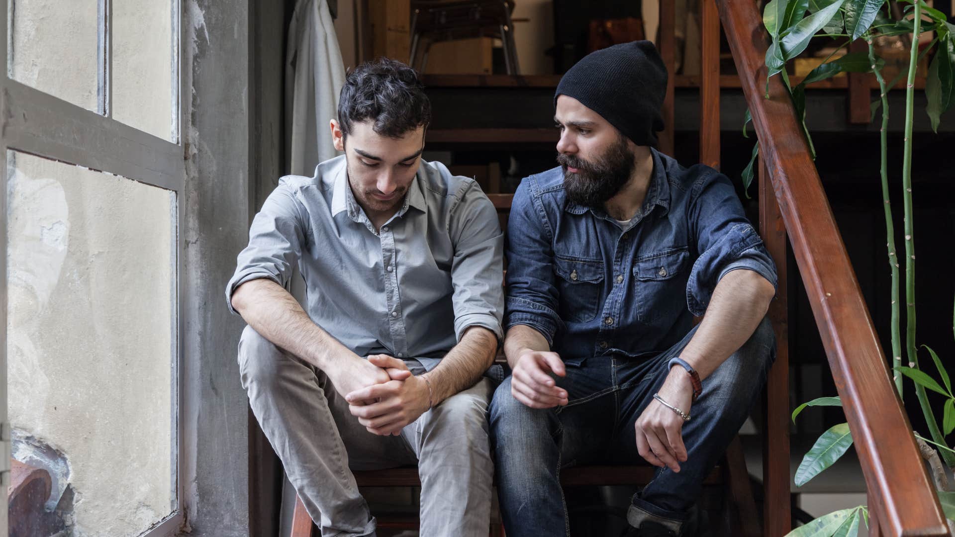 man in dark blue shirt telling man on stairs i didn't want to disappoint you 