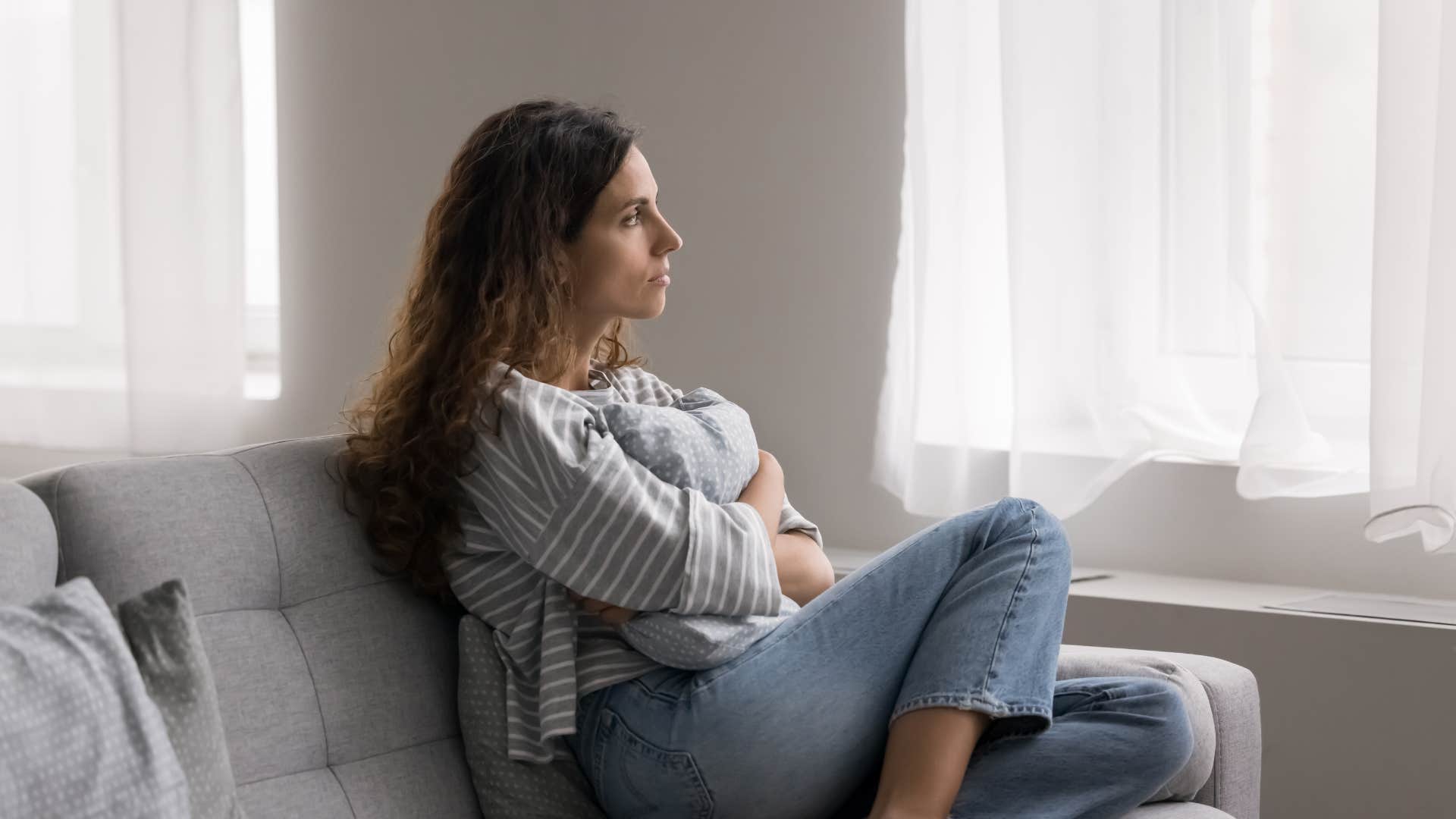 woman looking outside thinking i wish things were different but