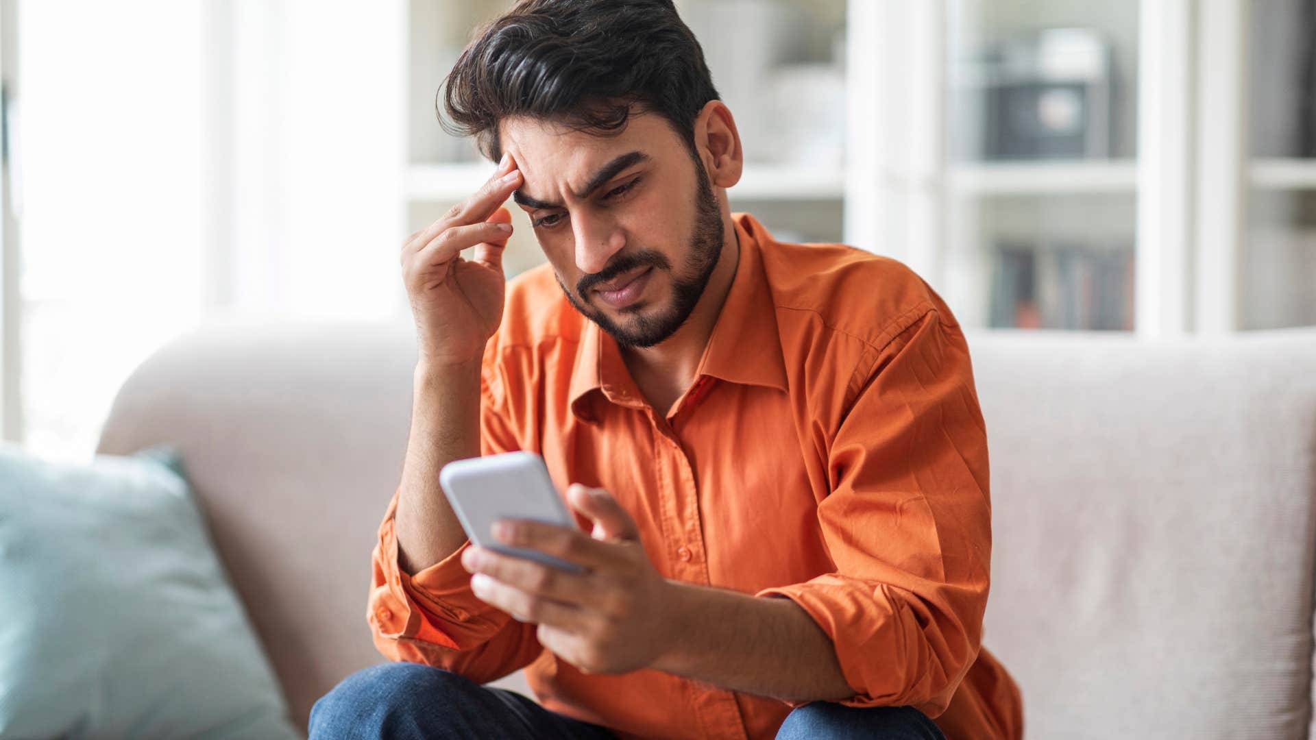 Man comparing themselves to others online.