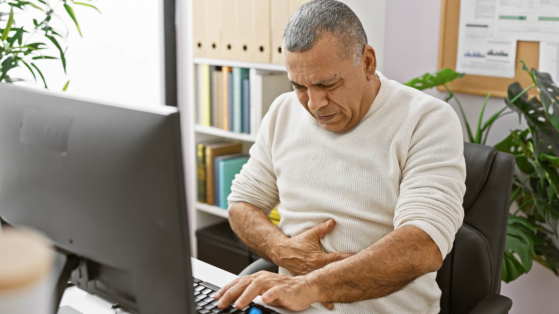 Man ignoring their health and working on their laptop.