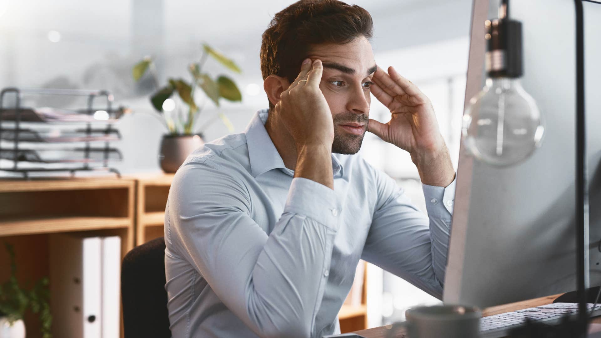 Man holding his head while tolerating bad jobs.