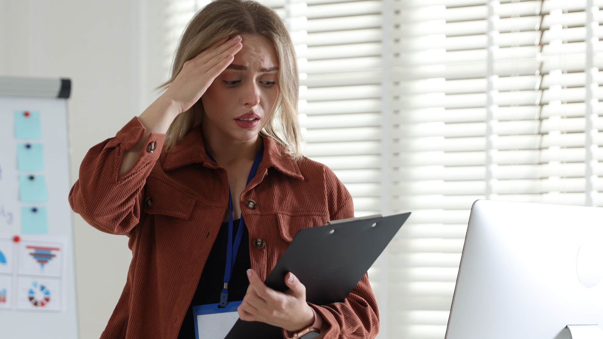 Woman who hates being the center of attention looking stressed at work.