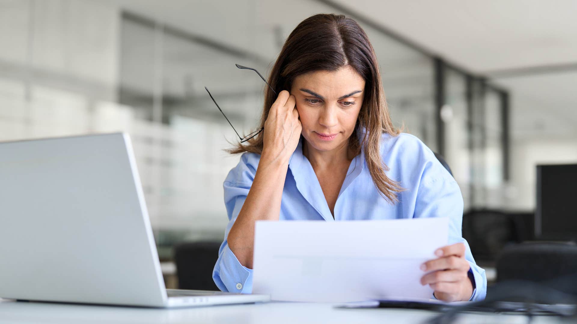 Annoyed woman looking at over-complications at work.