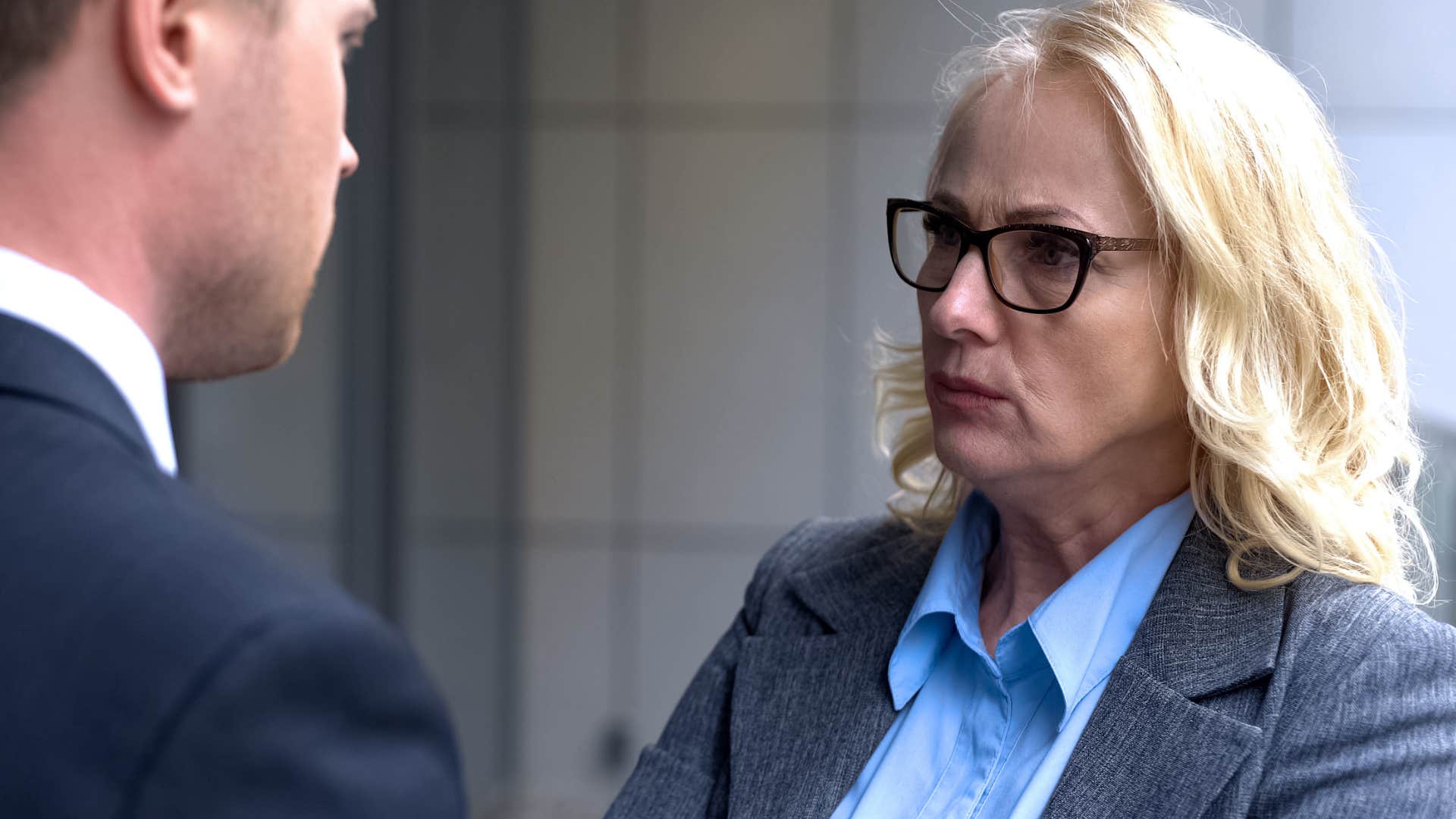 Woman thinking about subtle disrespect while glaring at a man.
