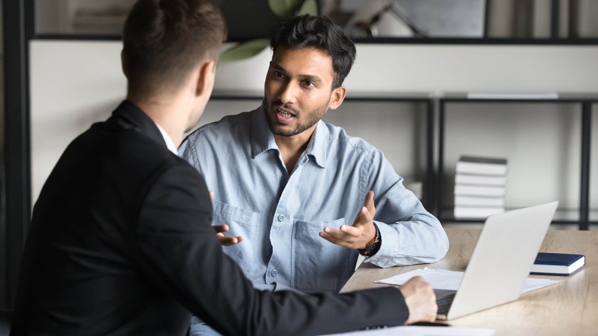 Man arguing about unnecessary competition with a co-worker.