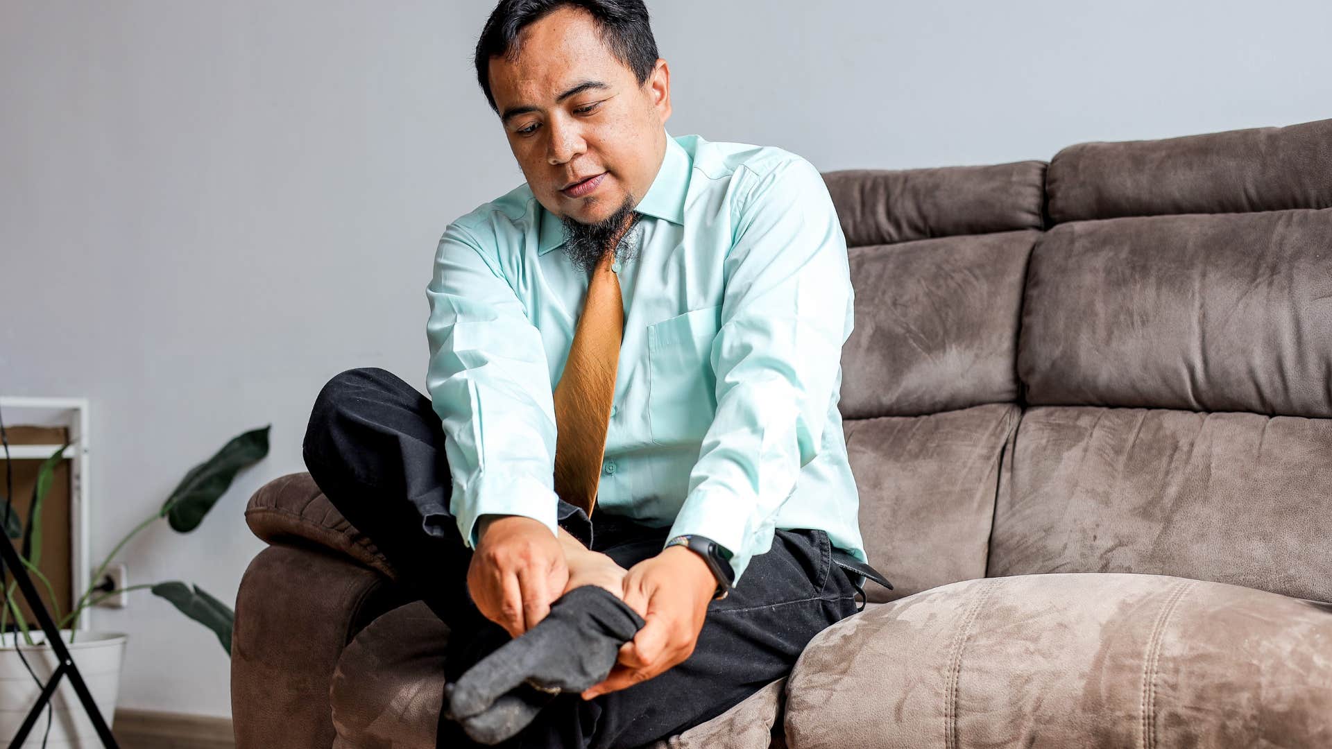 man putting on socks