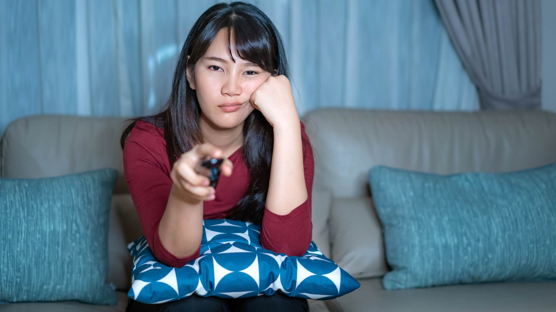 a woman watches reality television to give herself brain rot