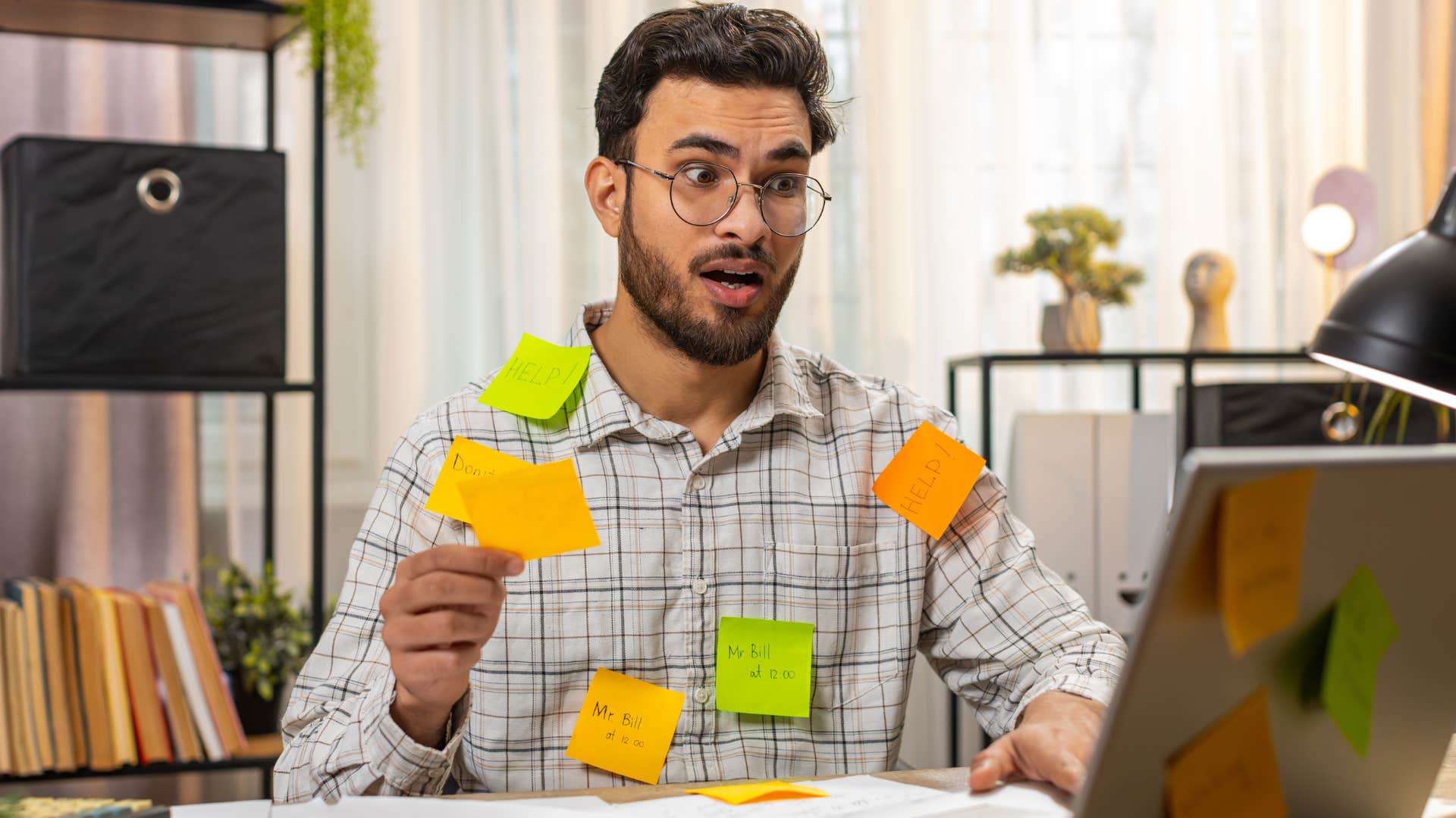 a man has sticky notes to remind him of everything and is now overwhelmed