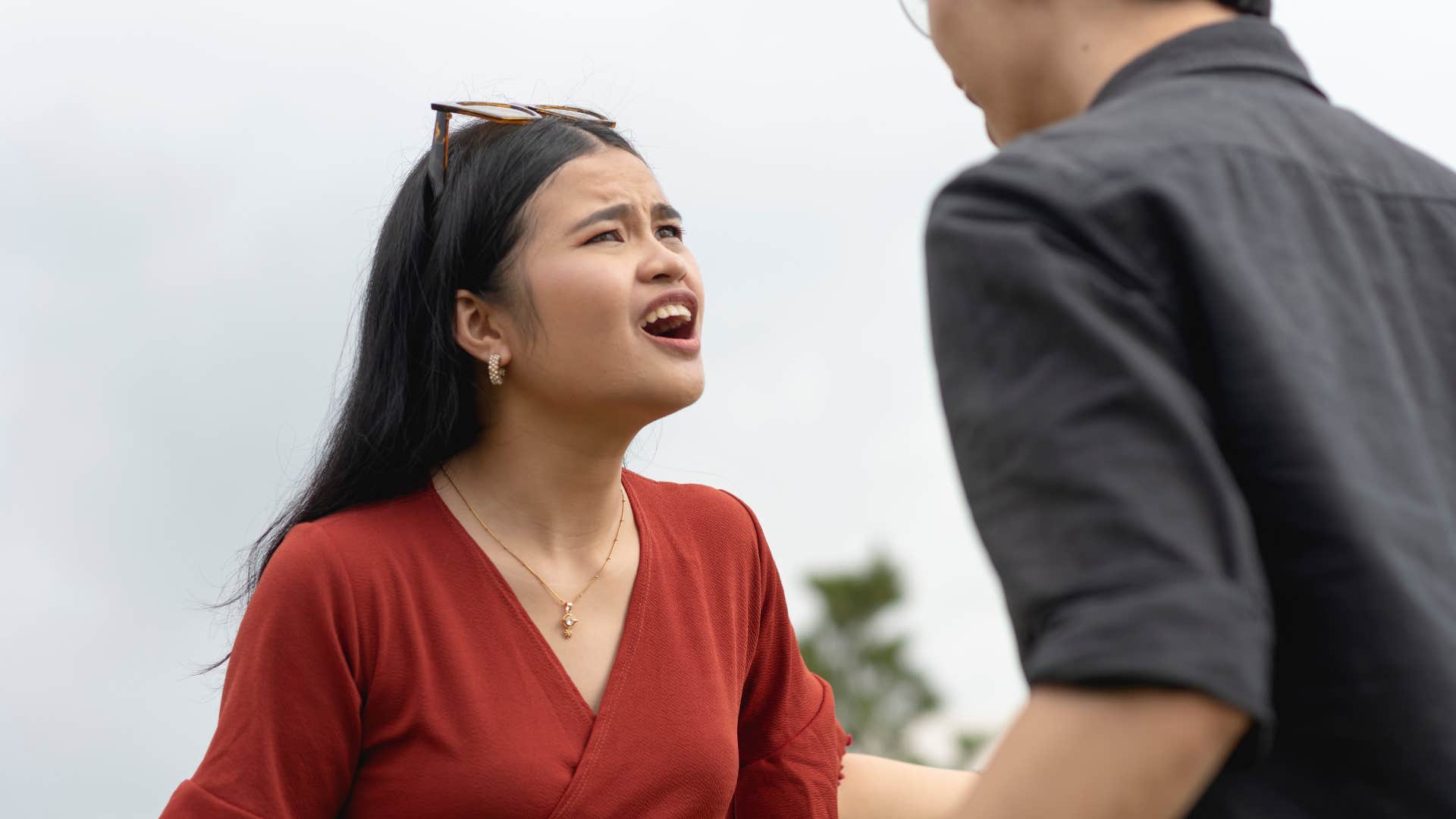 woman in red shirt publicly embarrassing man as she disrespects him