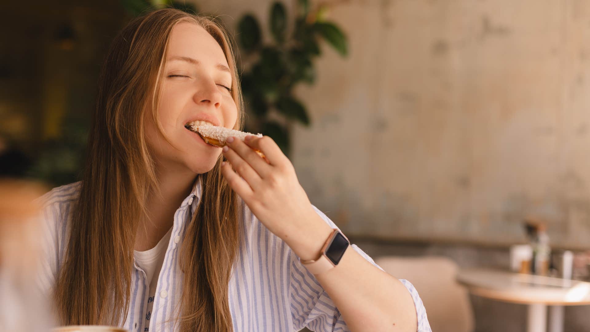 woman in stripped shirt doing mindful eating