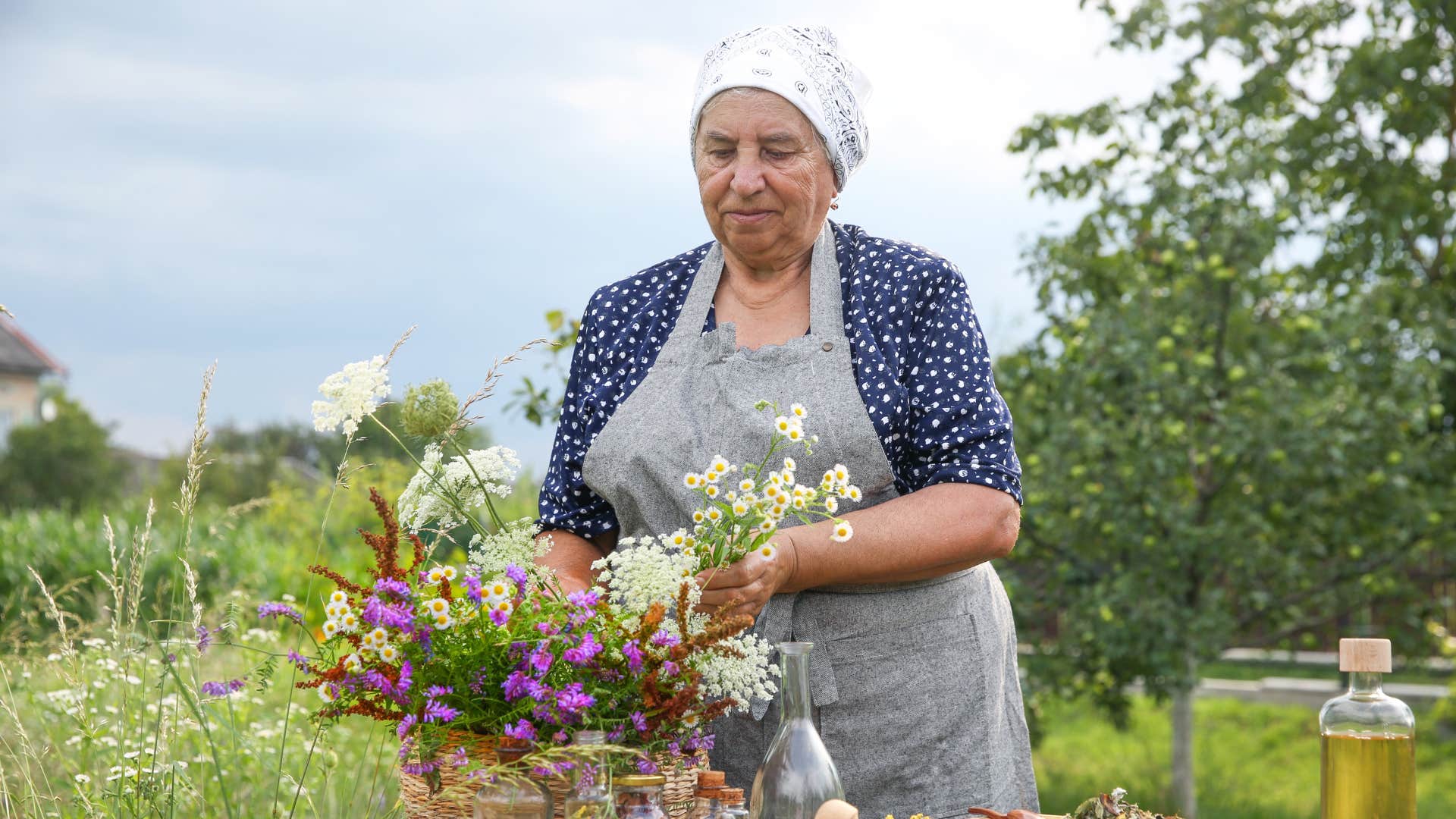 woman doing natural remedies as she gathers herbs 