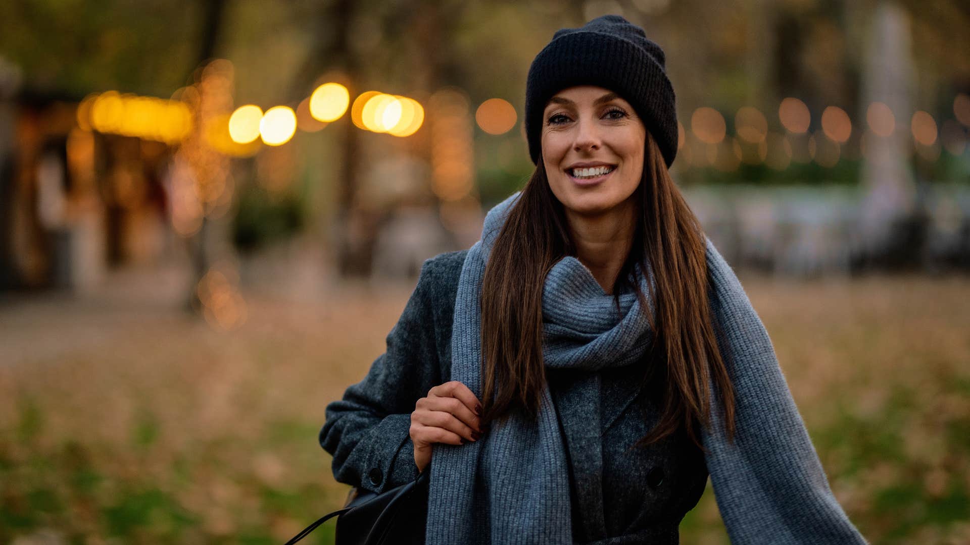 woman in sweater and scarf walking 10,000 steps per day