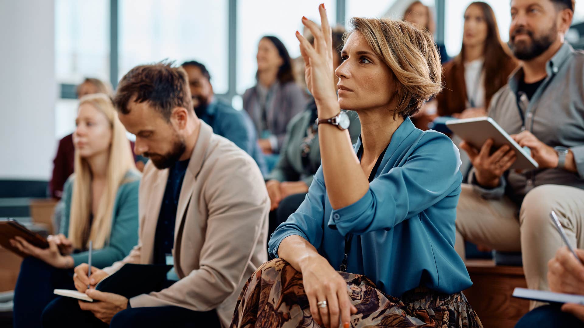 woman raising hand and asking questions without shame