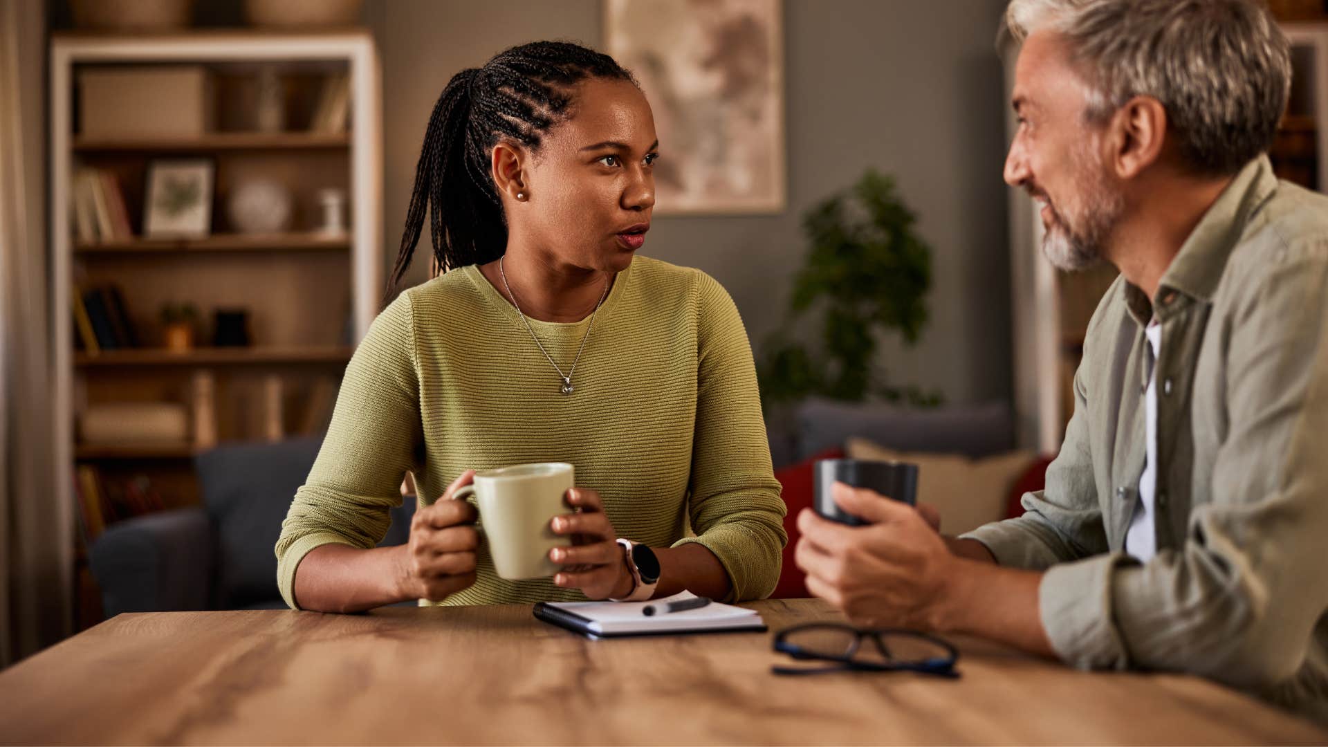 woman holding boundaries without guilt as she talks to man with cup of coffee in hand