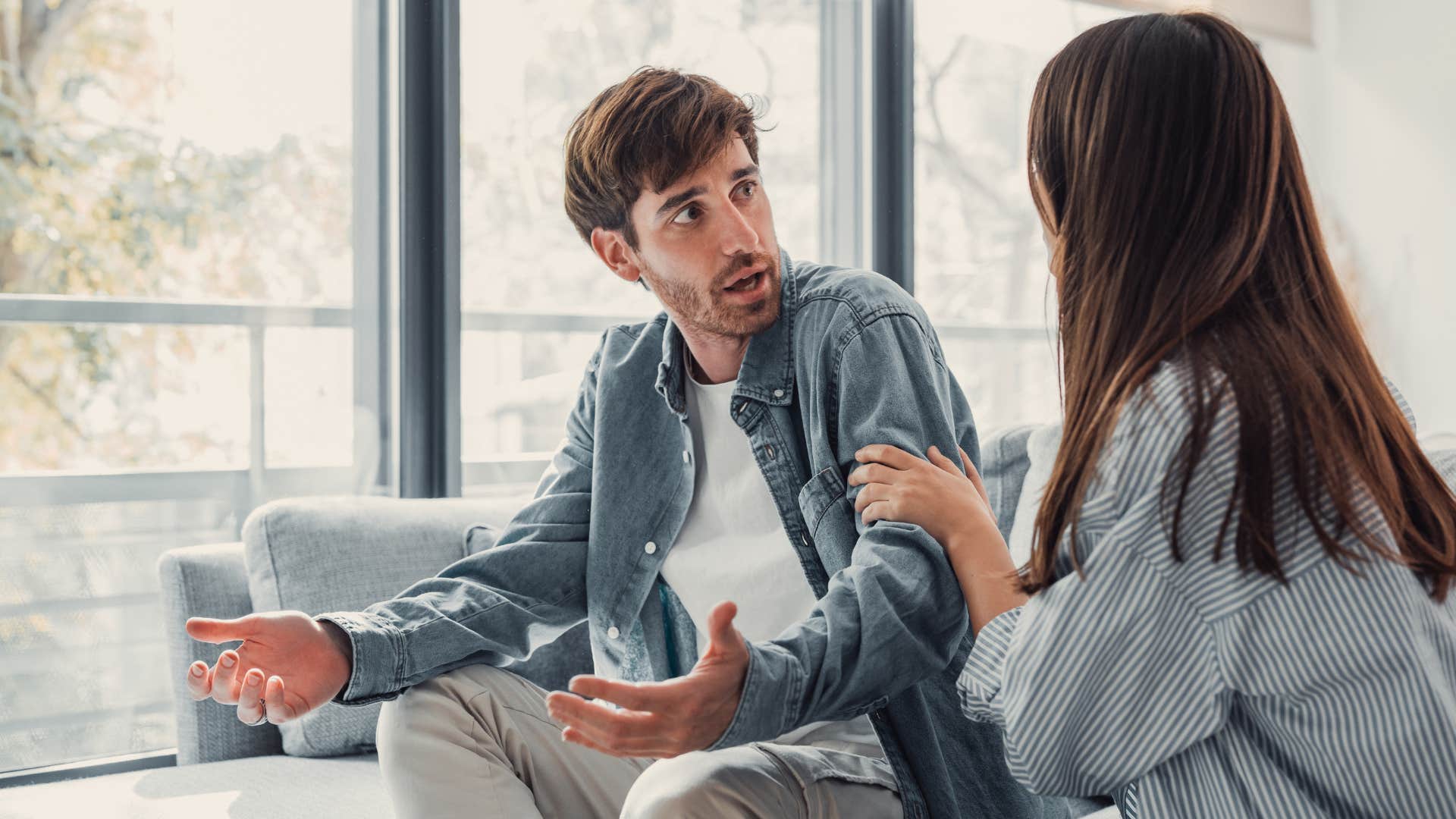 man rejecting help from woman as he shrugs her off