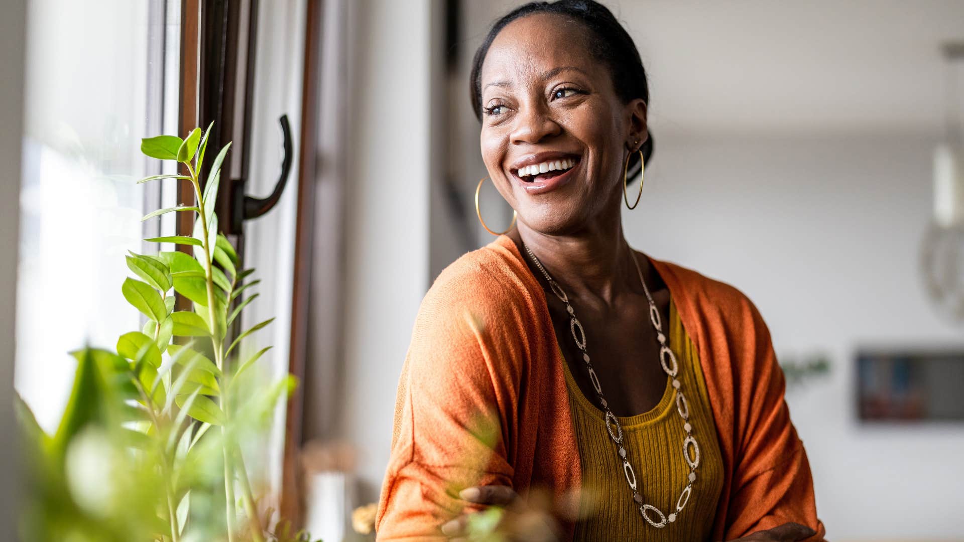 unmarried woman smiling about living in a home that reflects her identity