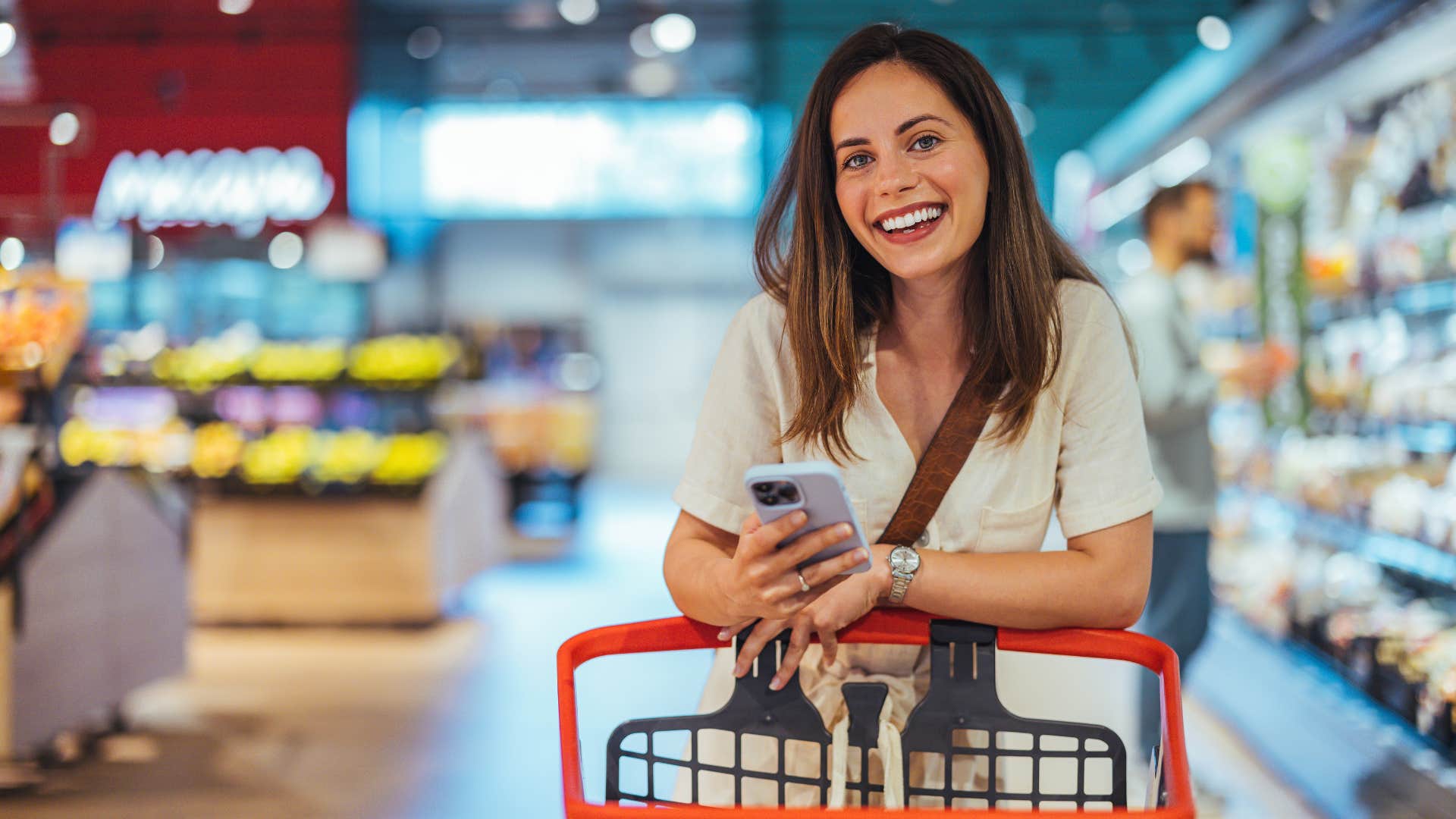 woman creating a grocery list as she grocery shops