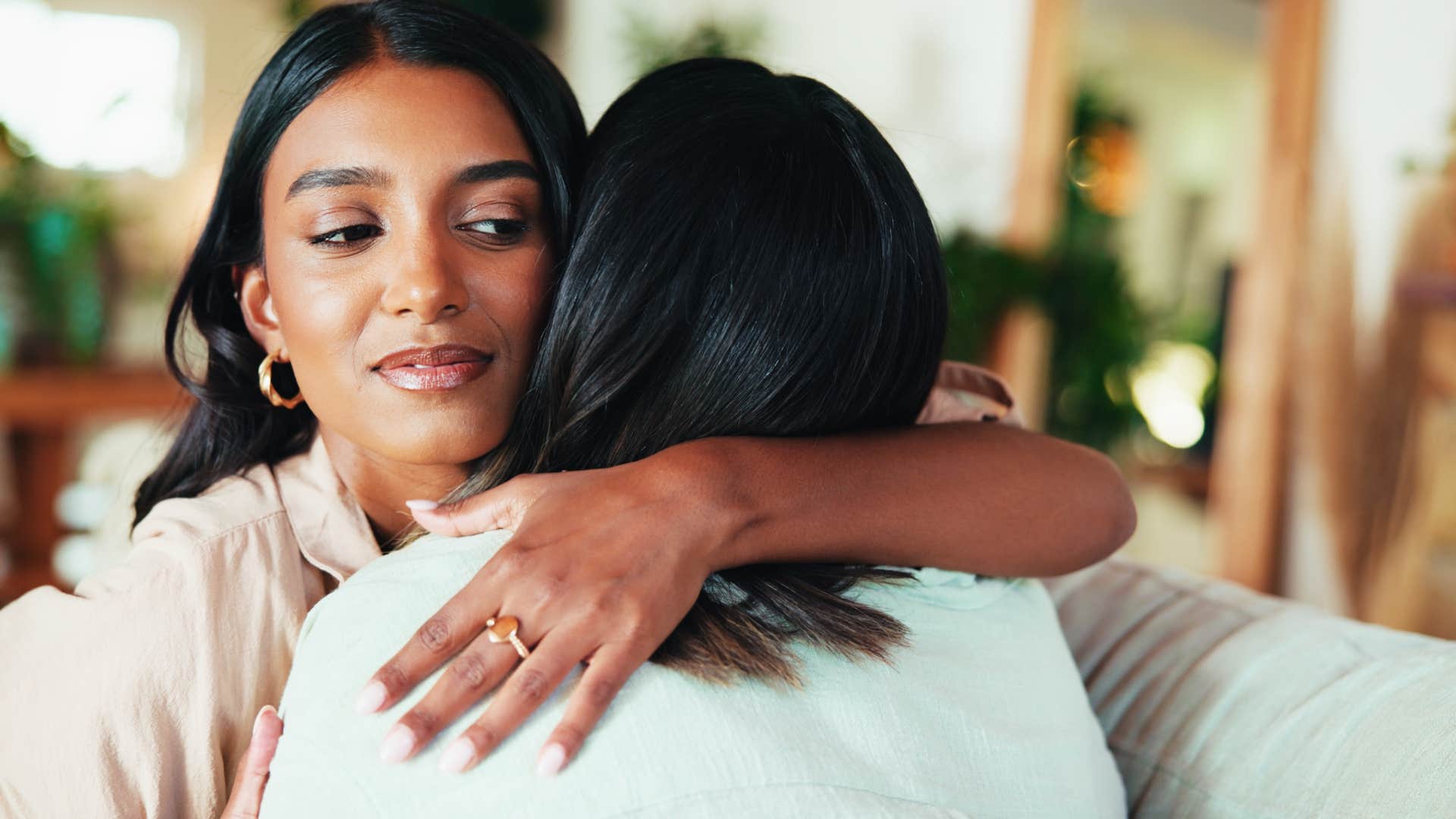 woman hugging parent after getting away with something
