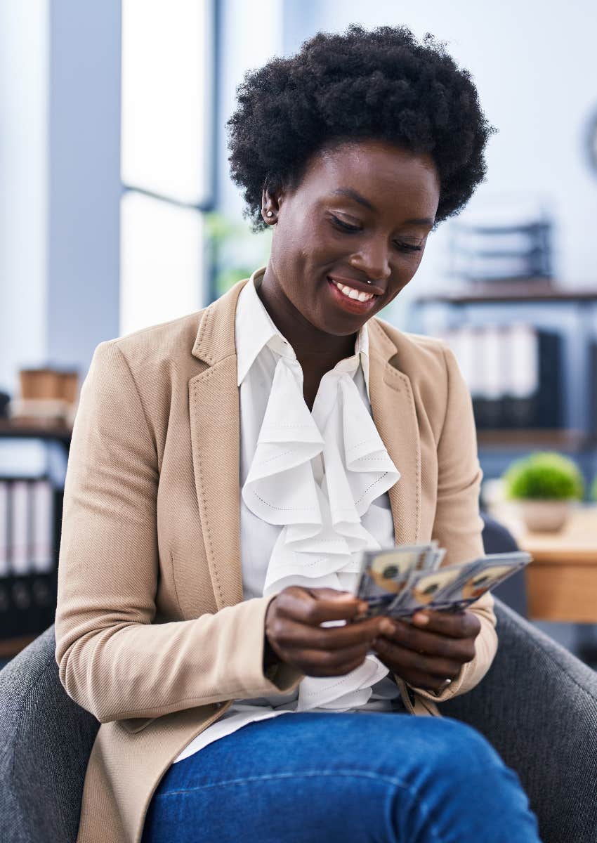 woman counting paycheck