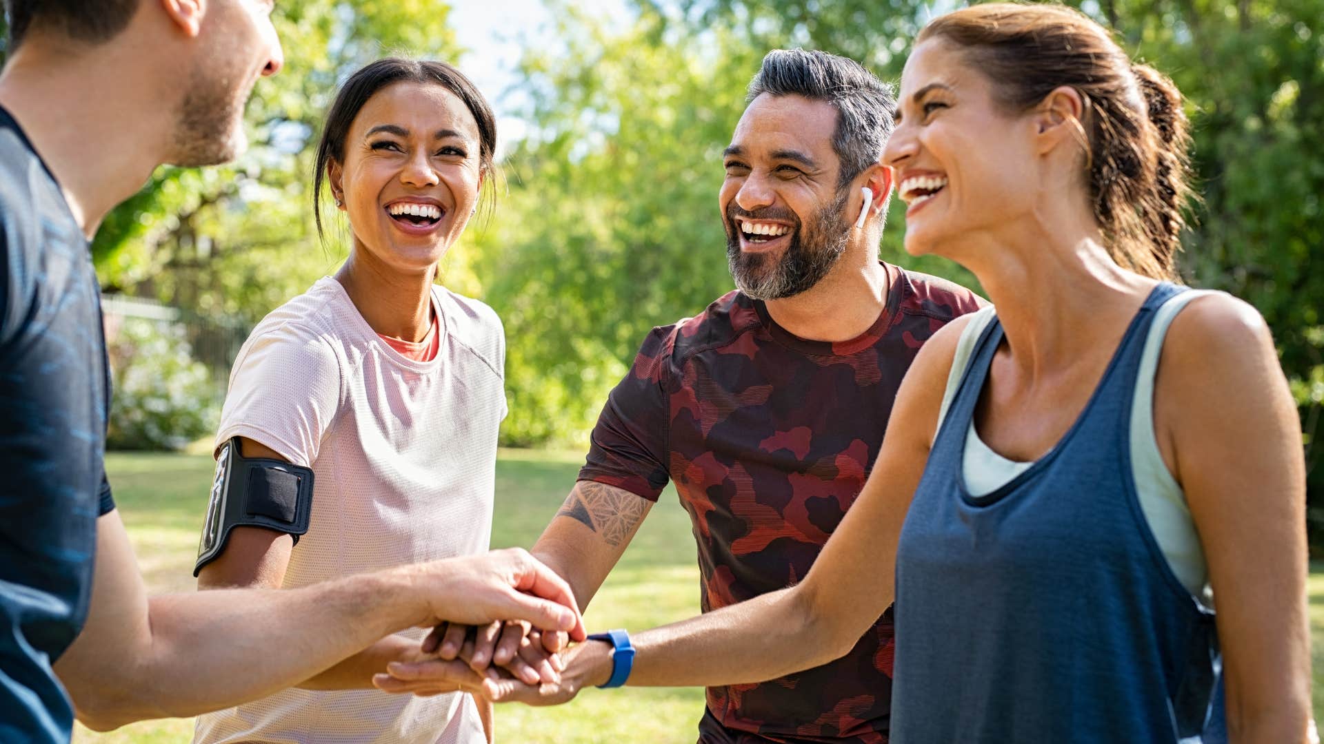 man smiling introducing his wife to friends