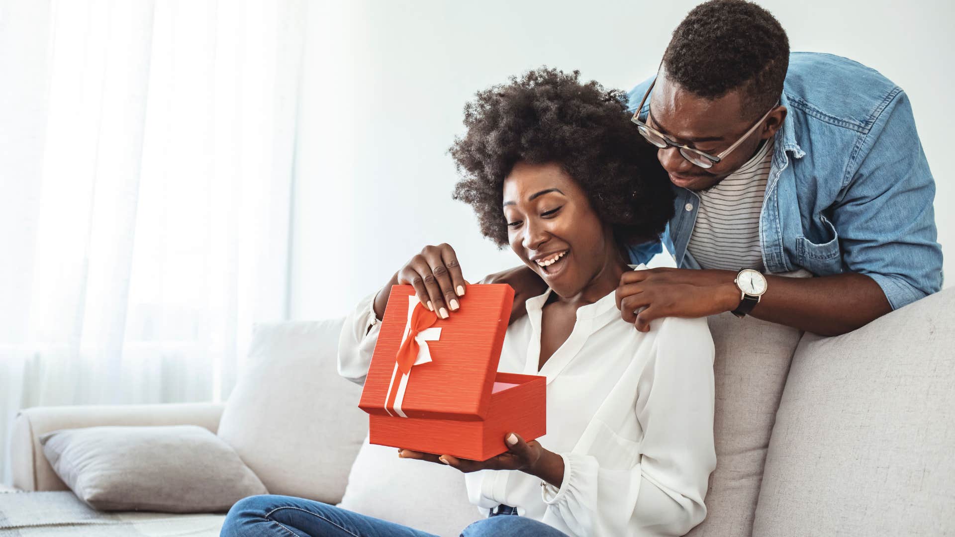 man giving intentional gifts to his happy wife