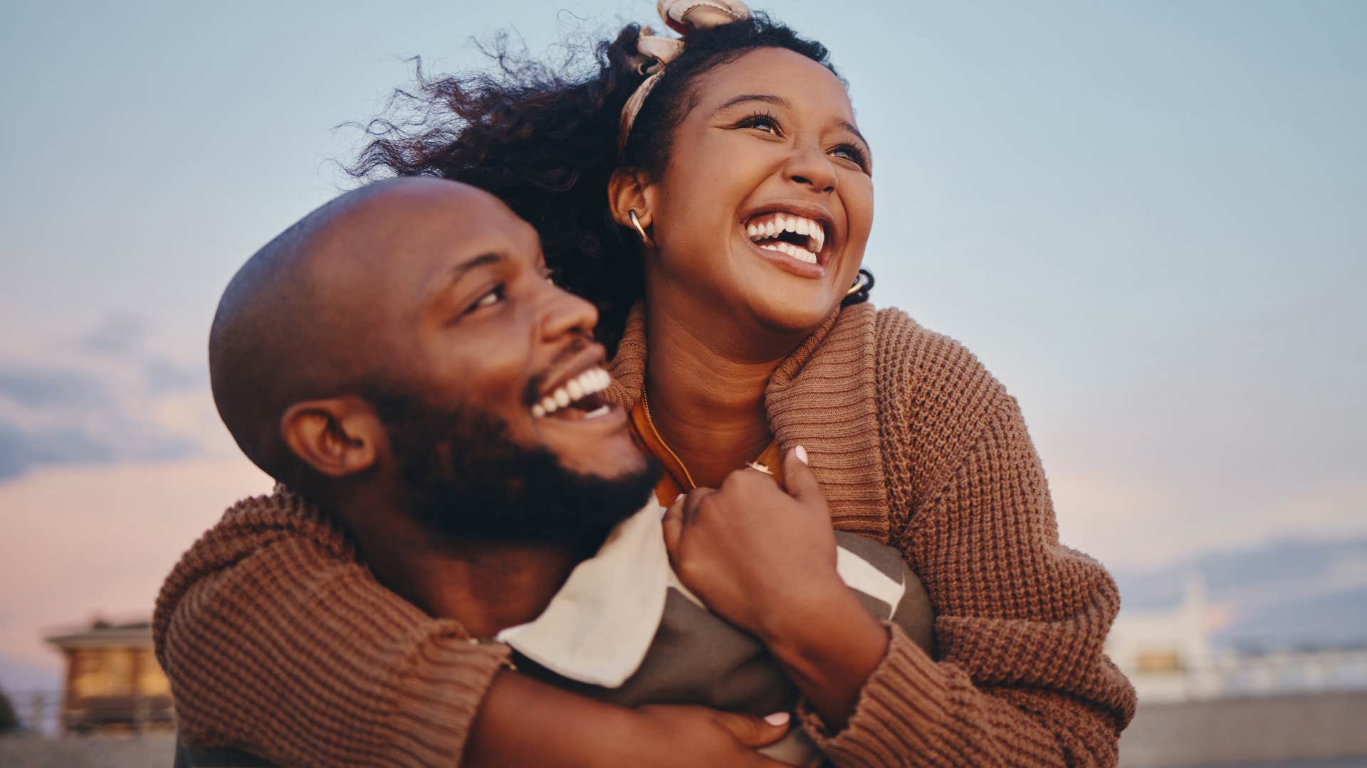 man smiling with his wife and mirroring her body language