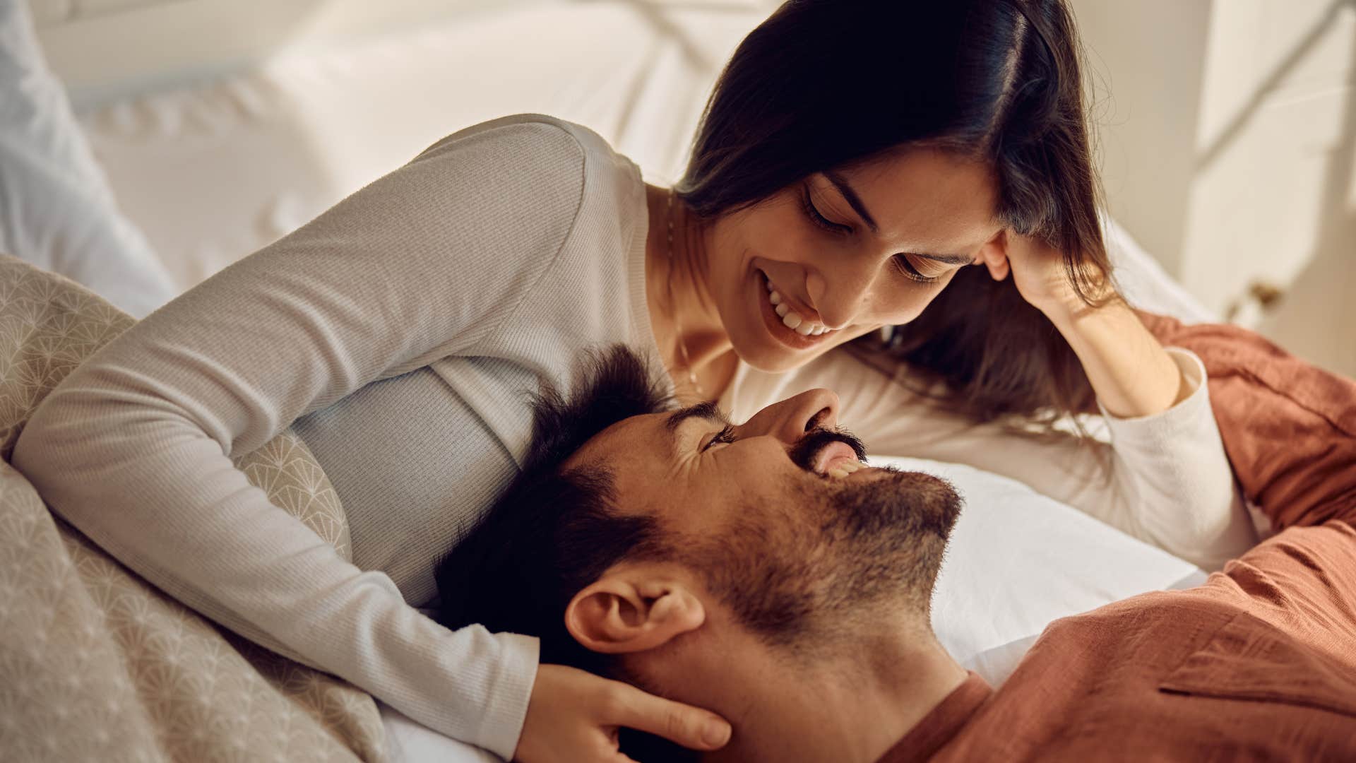 happy couple giving subtle physical touches to each other