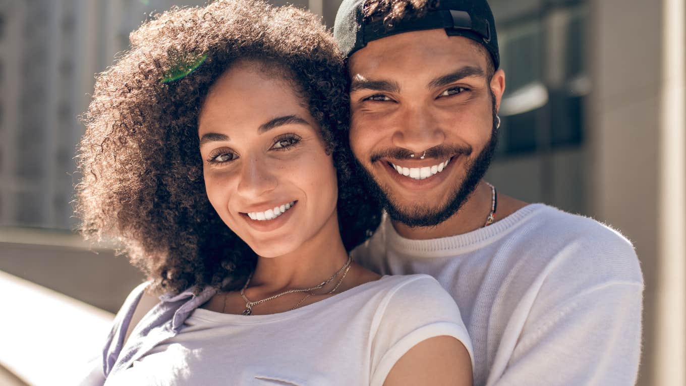 happy couple smiling snuggling close