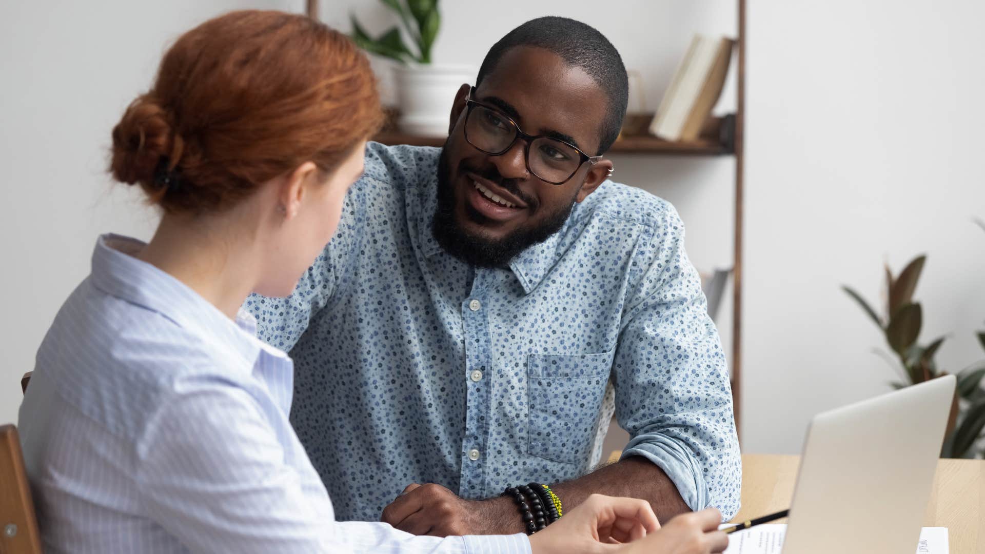 man listening to woman talk
